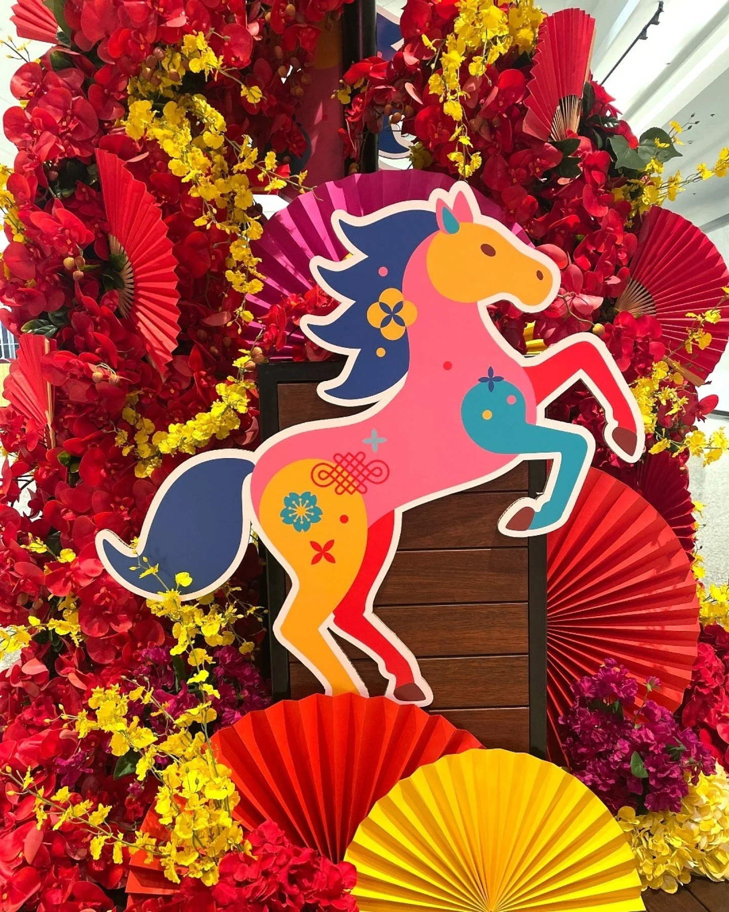 2026 is the year of the Fire Horse. We were inspired by this for the design of this floral installation @thesquaremirrabooka . Incorporating masses of red, yellow and pink florals and pleated fans to symbolise 'an auspicious year of transformation, g
