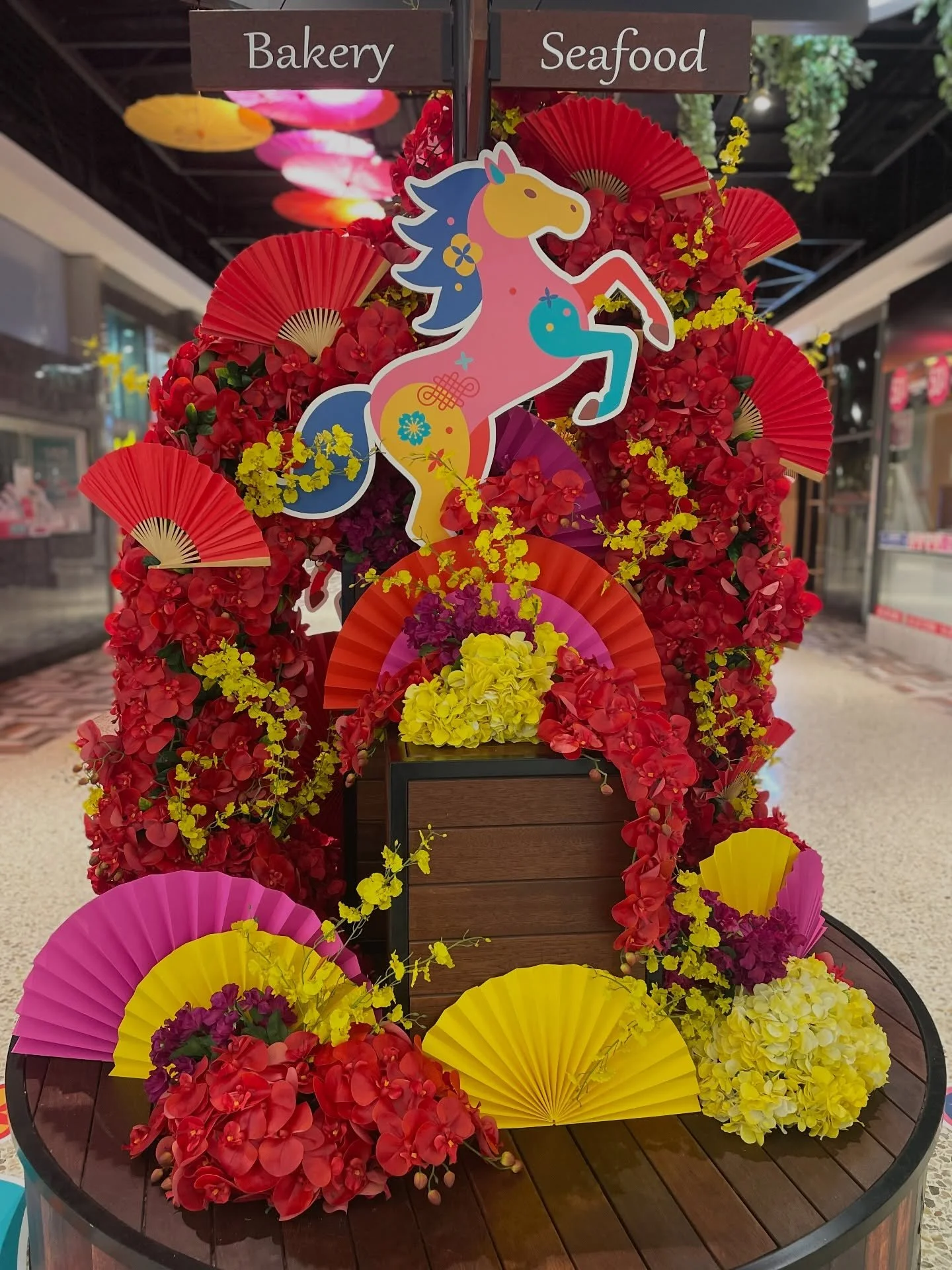 A vibrant colourful floral installation for that perfect Lunar New Year photo moment @thesquaremirrabooka 💛❤️🧡🏮 

Design, Props &amp; Styling by us
Print @cresults_ 
Hanging umbrellas @retailplaceco