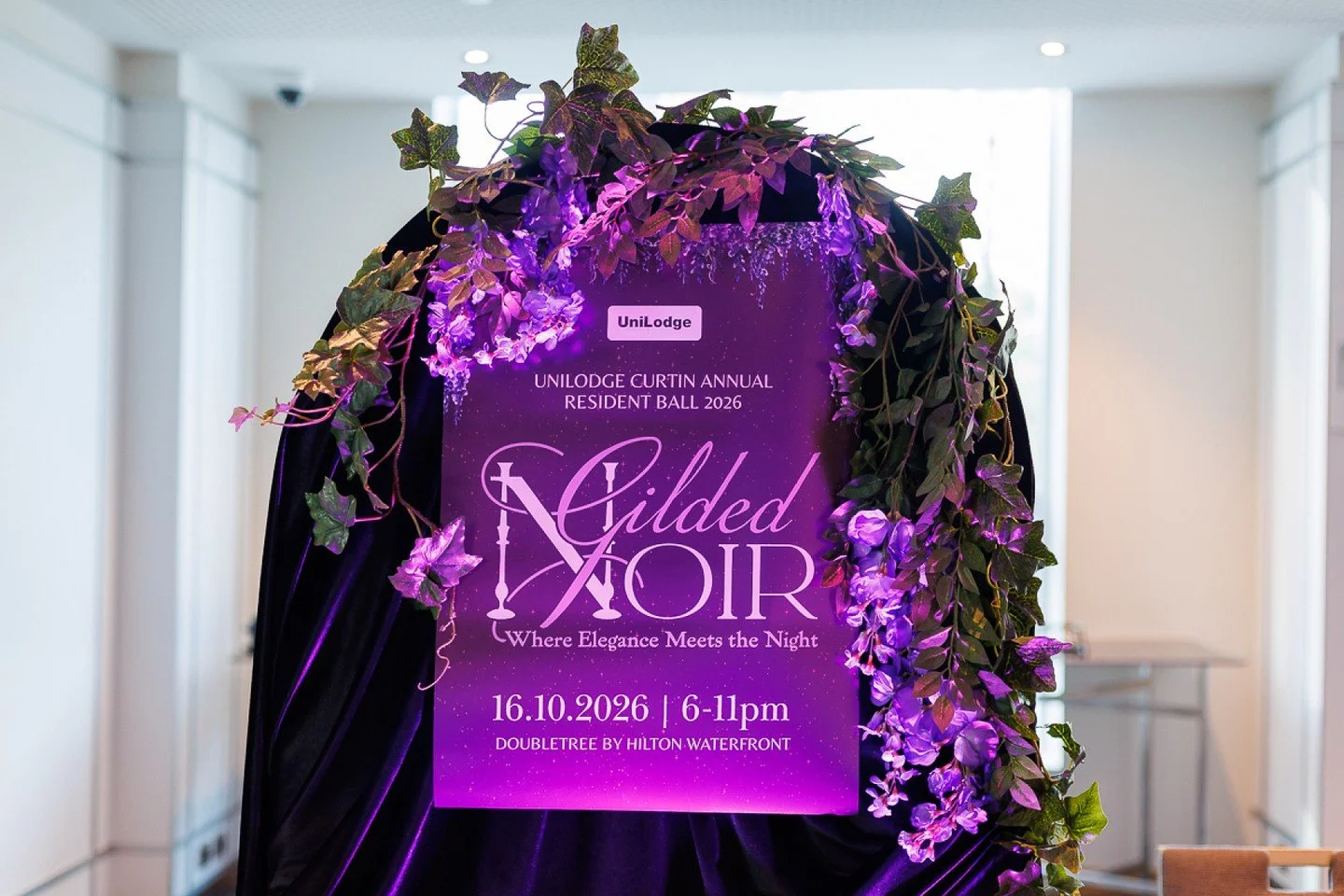 Taking inspiration from the @unilodgecurtin Gilded Noir theme, we combined rich black velvet, sheer aubergine chiffon and florals in deep burgundy, purple and vibrant greens. We love the contrast of textures, particularly the softness of the chiffon 