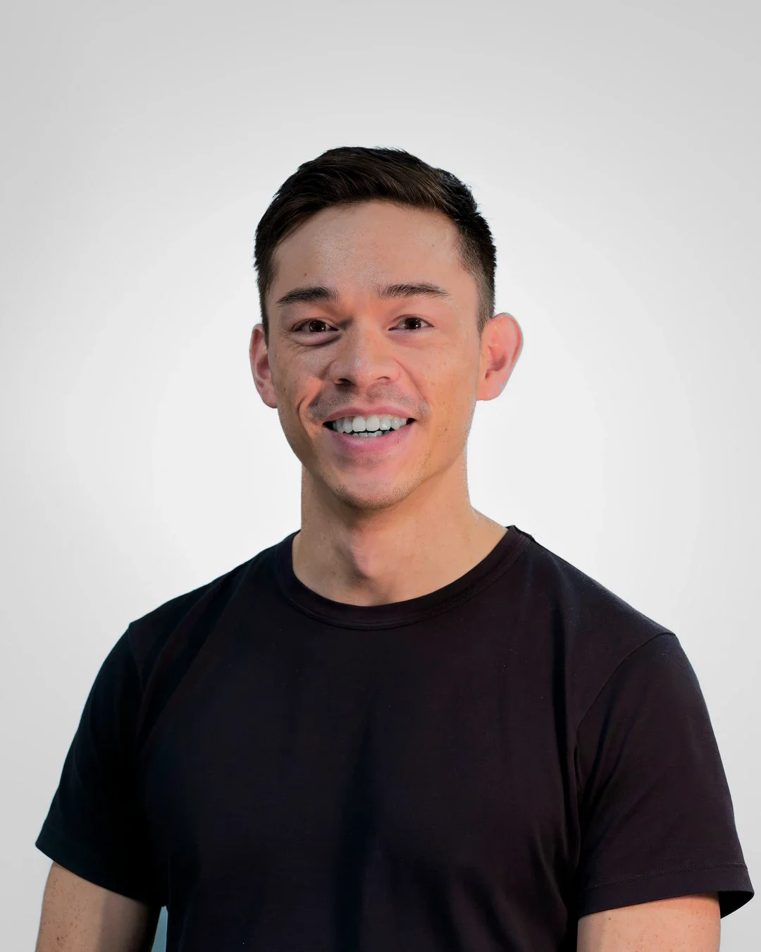 Male physiotherapist smiling in his headshot photo
