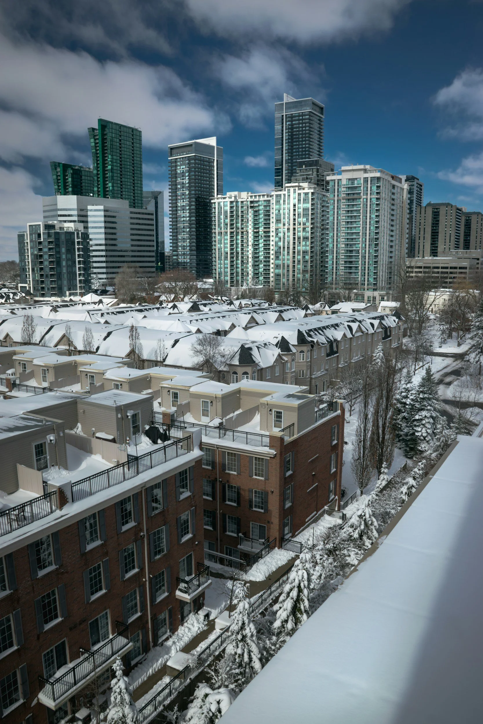 City skyline with modern glass towers and snow-covered rooftops