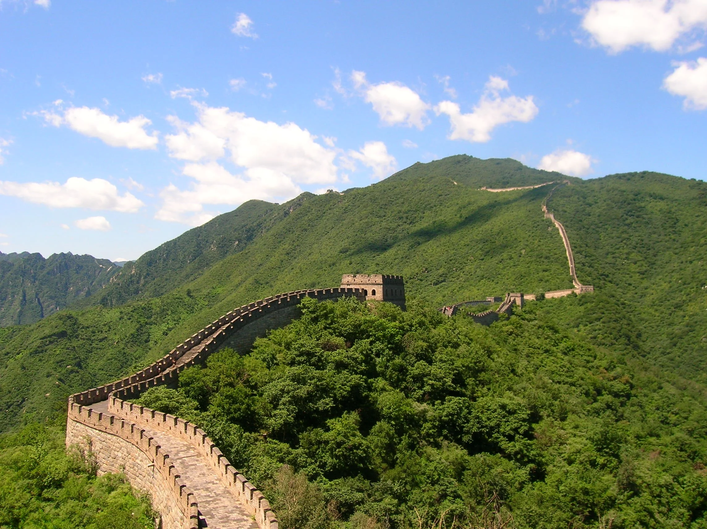 The Great Wall of China winding across green mountains at Mutianyu near Beijing