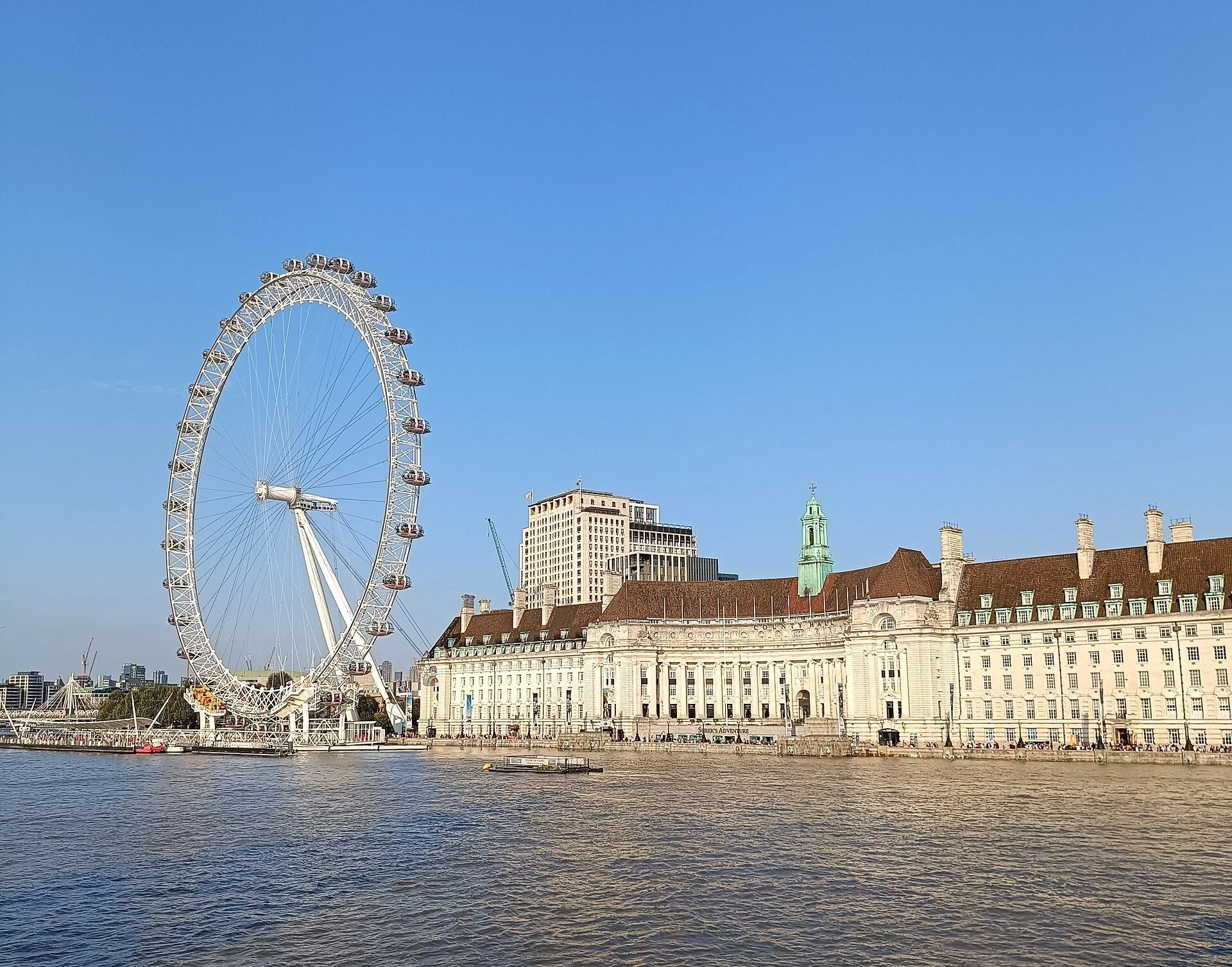 The London Eye and County Hall beside the River Thames in London