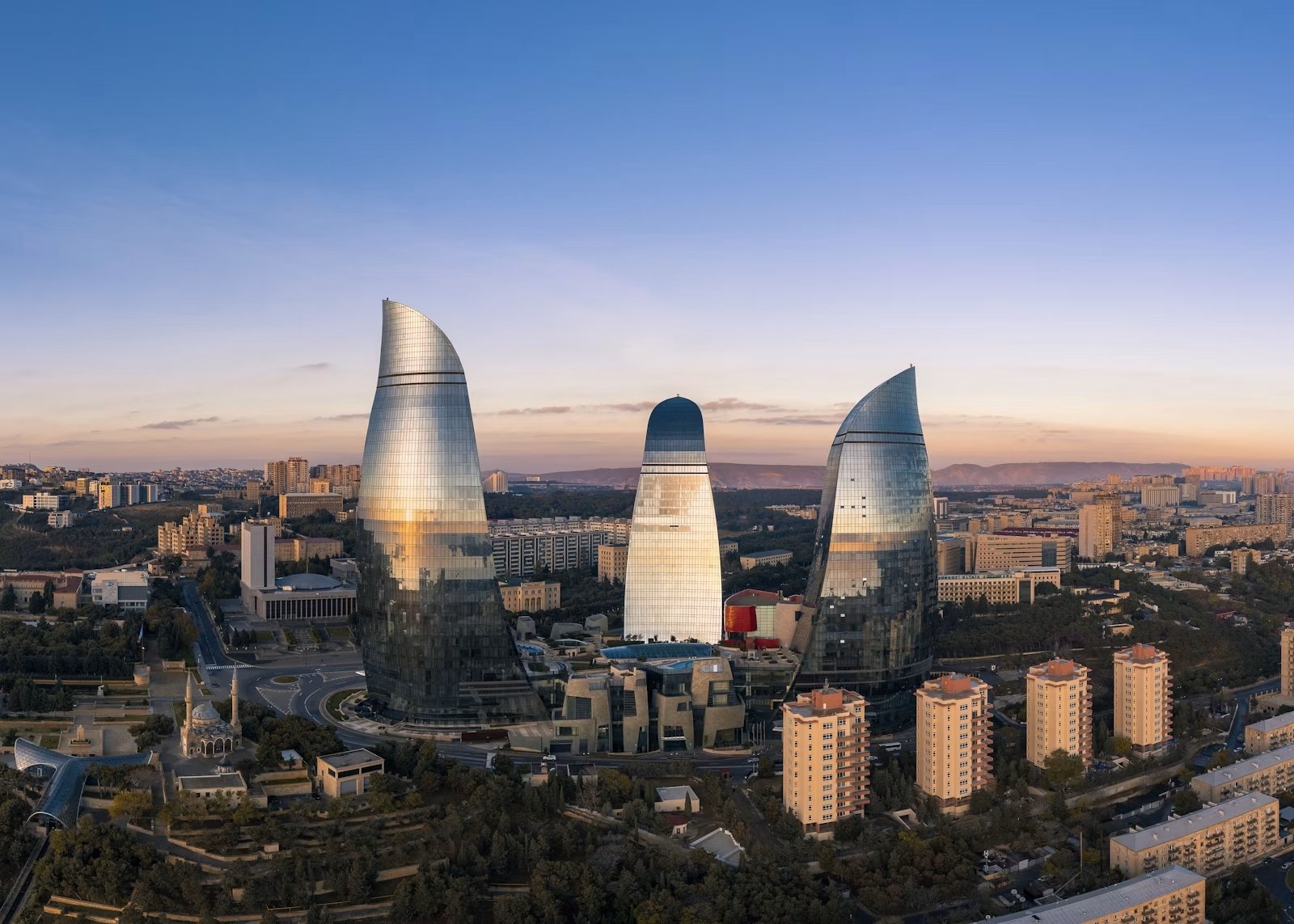 Baku skyline with the Flame Towers under a blue sky.