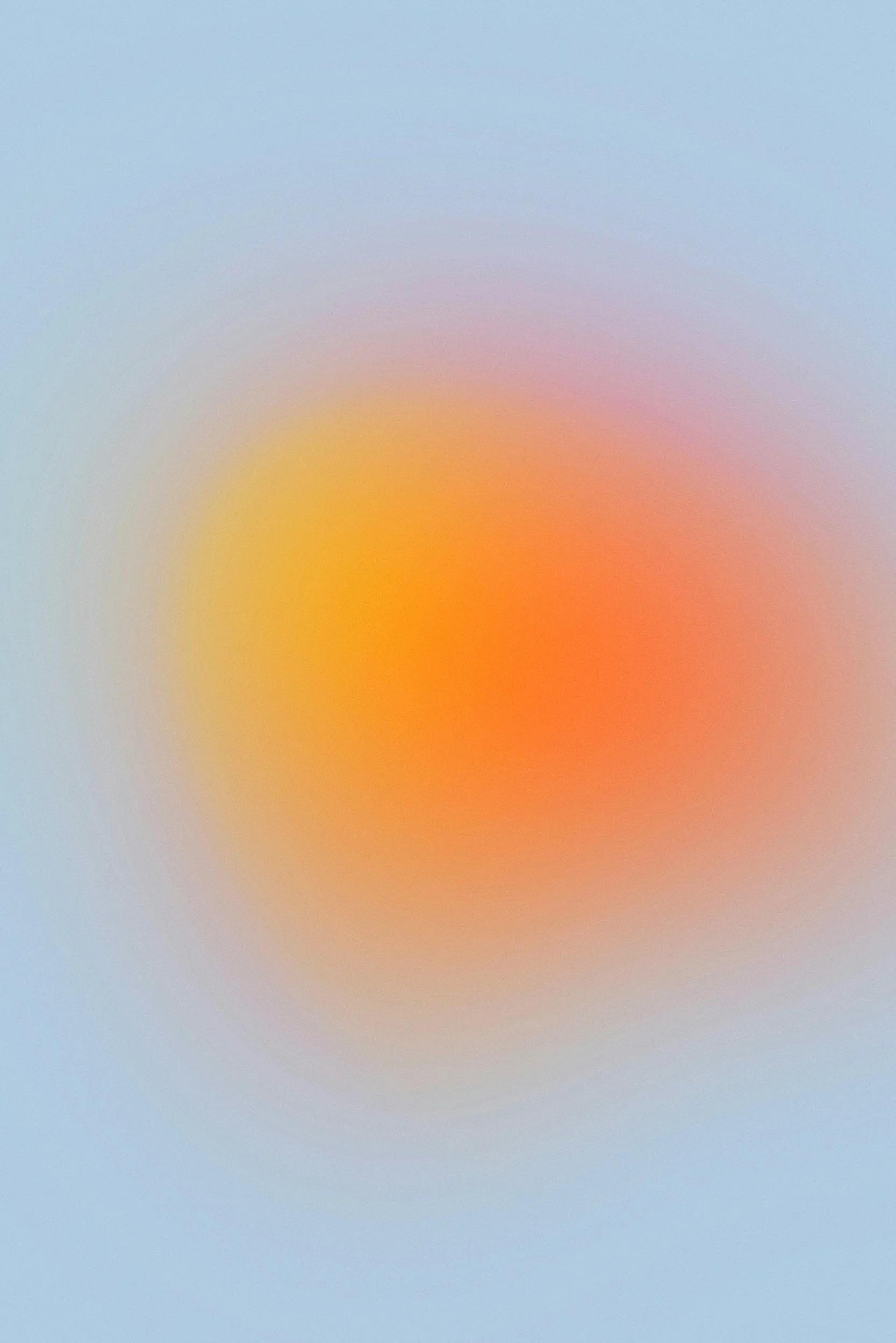 Blurred abstract background with gradient colors of blue, yellow, orange, and pink.