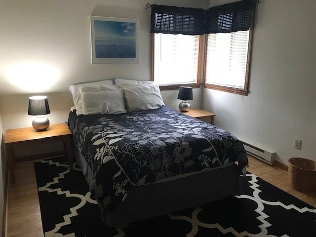 This bedroom is located upstairs on the right.