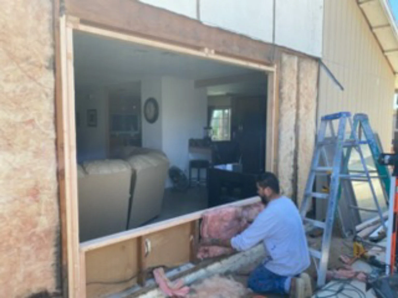 Residential window opening prepared during an exterior improvement project