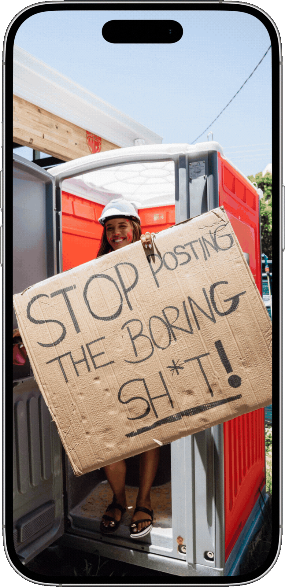 A woman wearing a hard hat is holding a cardboard sign that reads, 'STOP POSTING THE BORING SH*T!' while standing inside a utility vehicle.