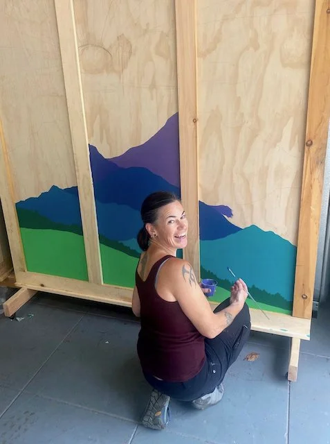Emily painting a mural
