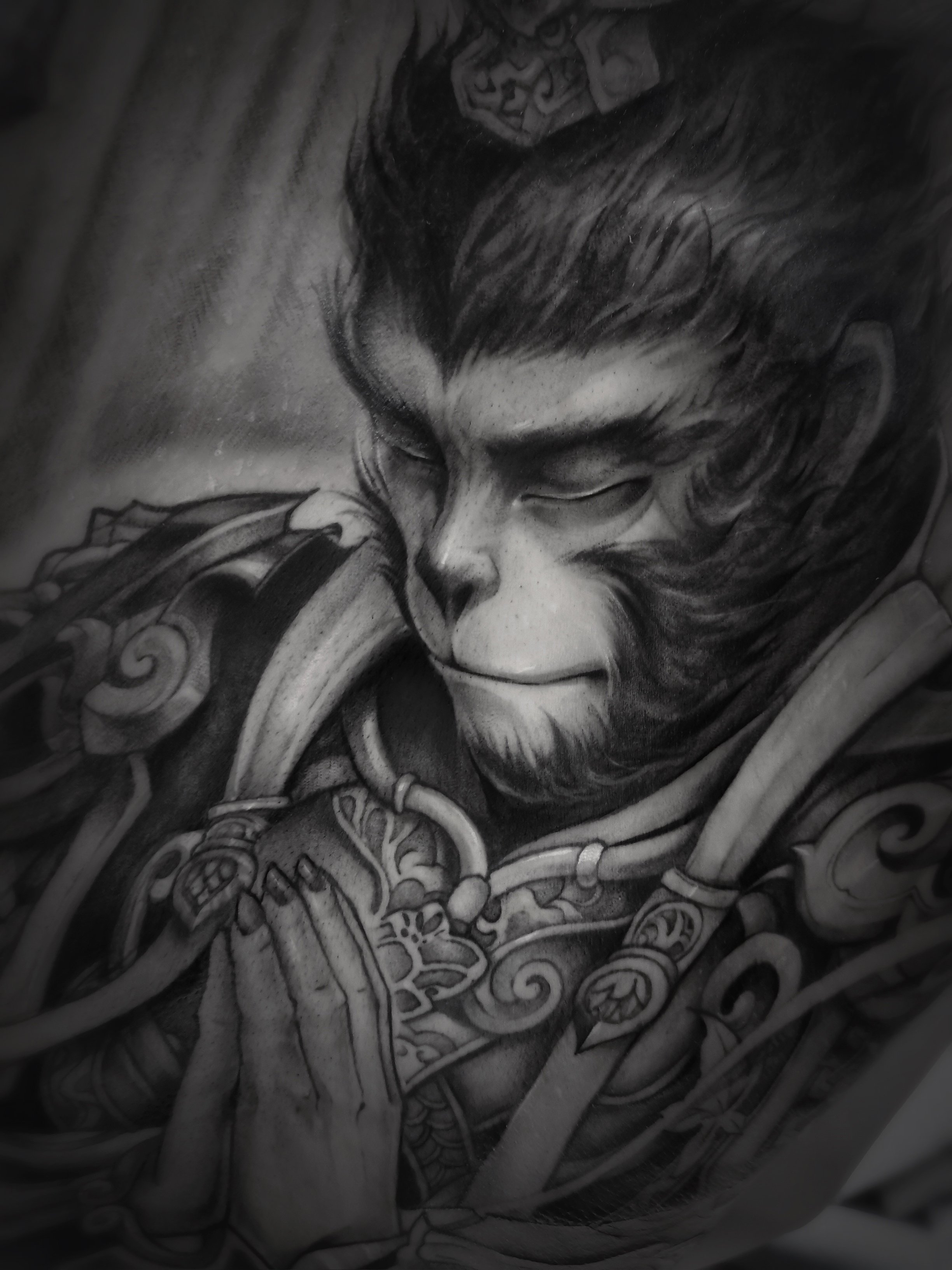 Tattoo of a mythical monkey figure in armor with closed eyes, praying hands.