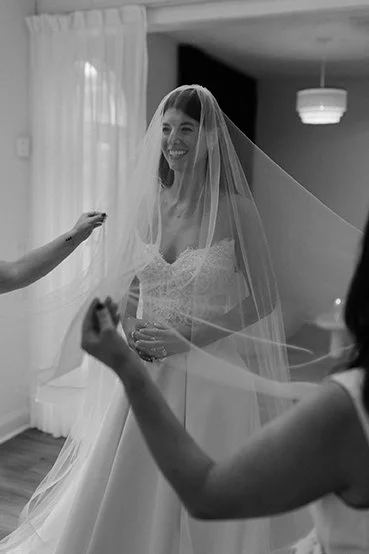Bride trying on a wedBride trying on a wedding dress at Aisle Studio bridal shop in kansas cityding dress at Aisle Studio bridal shop in kansas city