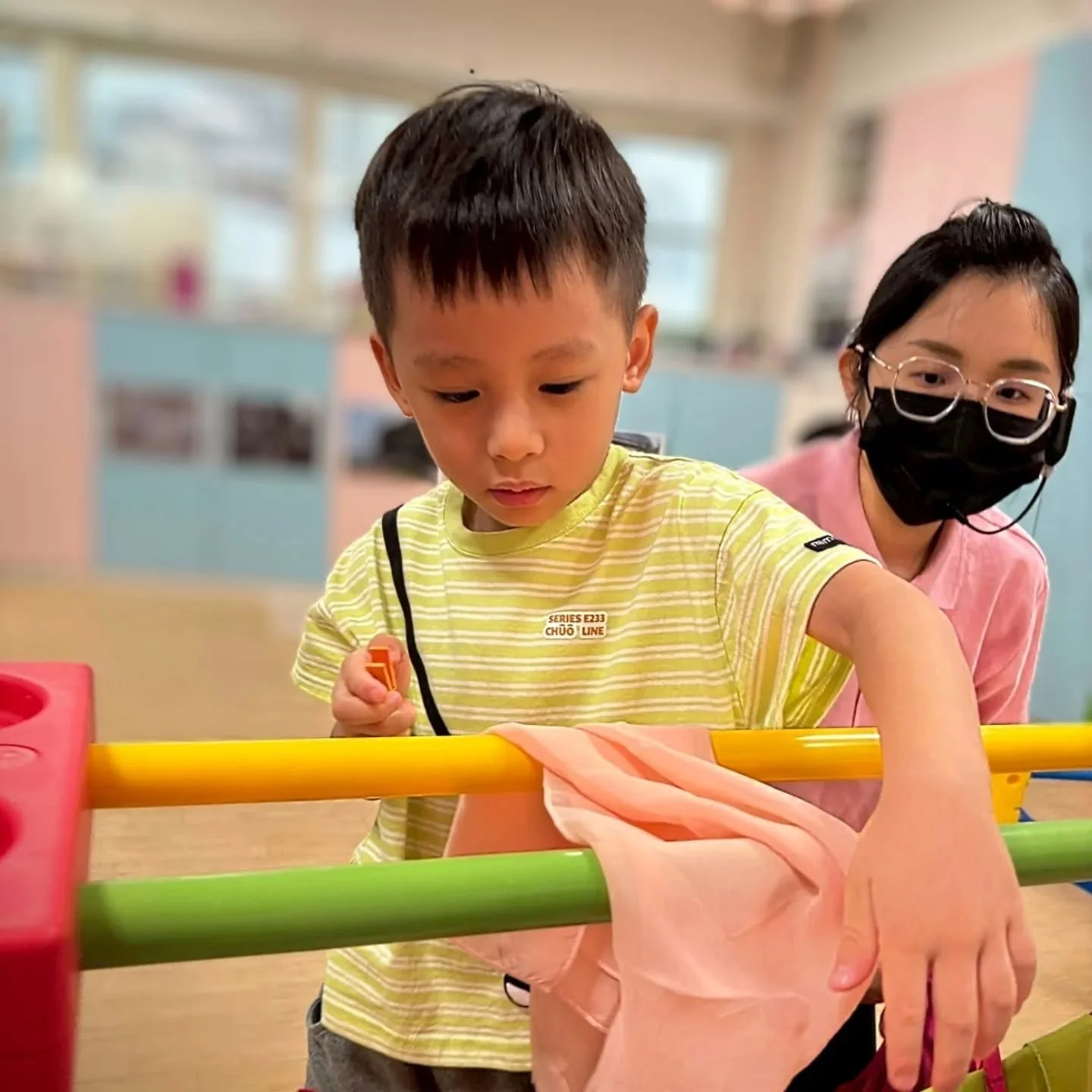 👕【PG4共學活動|媽媽最棒的小幫手】
你知道嗎?簡單的「曬衣服」,其實是孩子進入未來生活自理、組織思考、專注力與情緒穩定的起點喔!在學齡前的黃金時期,孩子從生活中學會動作與概念,是最自然、最有效的學習方式。
這週的課程,我們帶孩子一起練習「曬絲巾」,讓他們化身家裡最棒的小幫手。孩子們認真選顏色、握住曬衣夾,仔細地將絲巾一條條夾上曬衣線,在動作中學會協調、觀察與秩序,畫面療癒又充滿成長感。
✨為什麼要學曬衣服?原來可以帶來這些學習力:
・小手肌力與精細動作發展:曬衣夾的使用,訓練手指