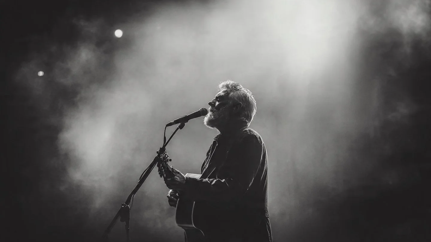 an_older_male_indie_folk_singer_singing.jpeg
