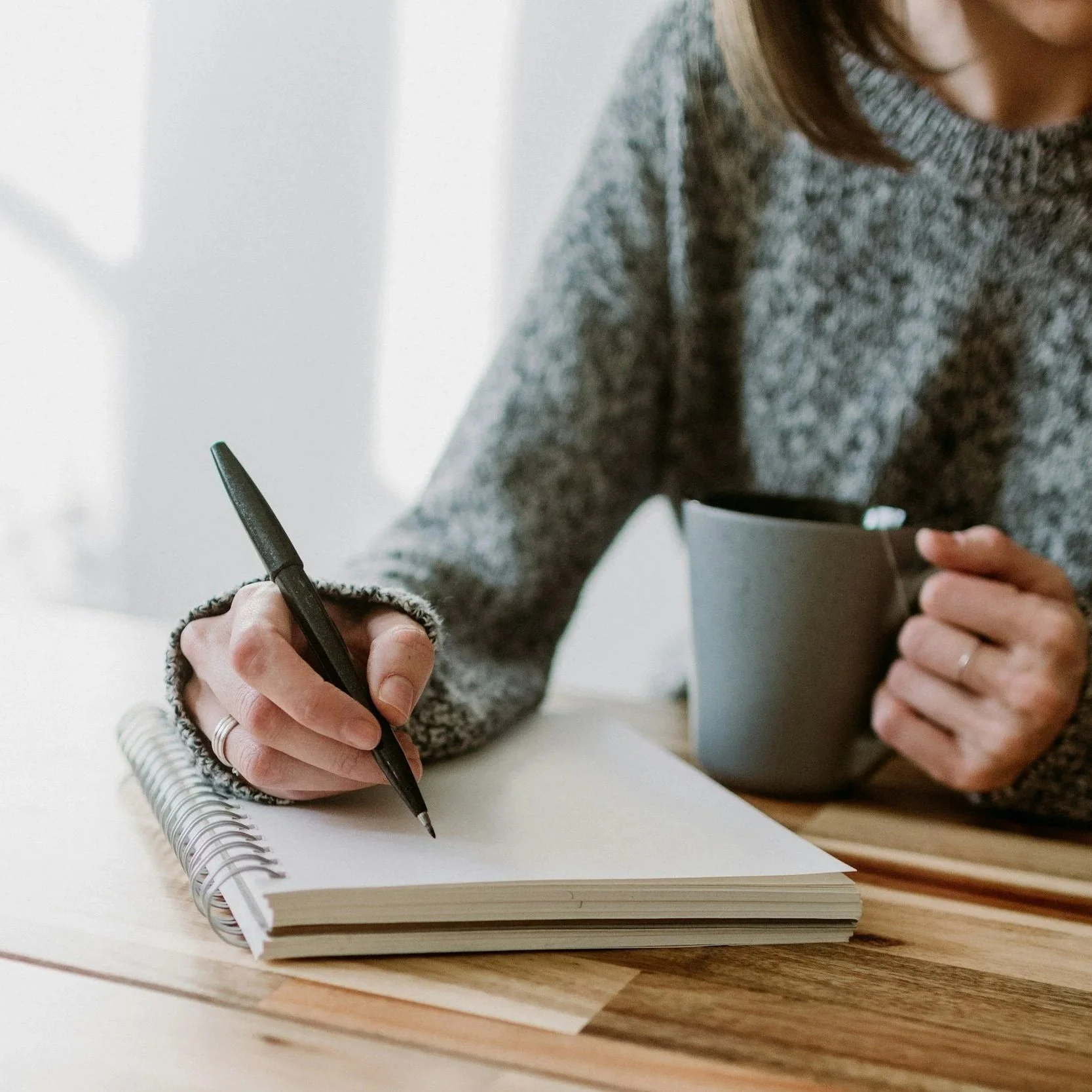 Ann J. Fowler writing The Course You Choose book on faith, homeschooling, autism, and divorce. Picture of a woman writing.