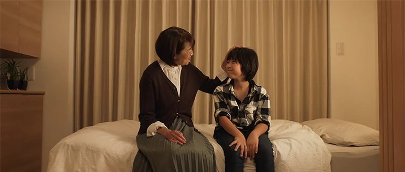 母親と子供がベッドの上で話している。