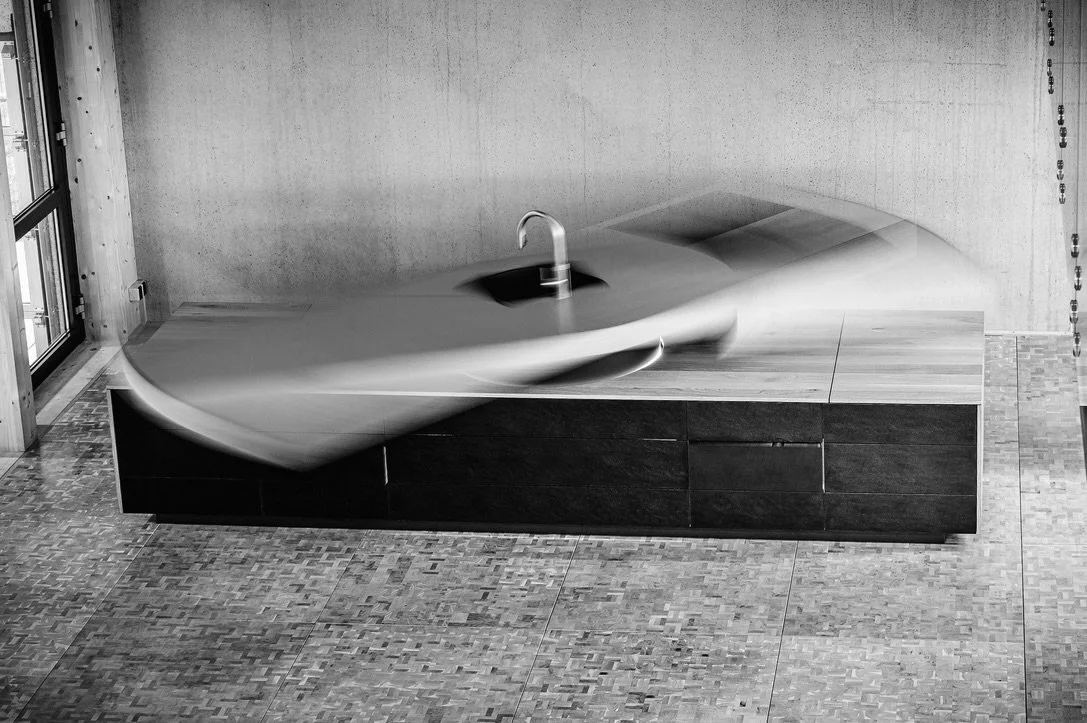 Integrated solid wood kitchen island forming the spatial centre of a contemporary living environment by IMHMV.