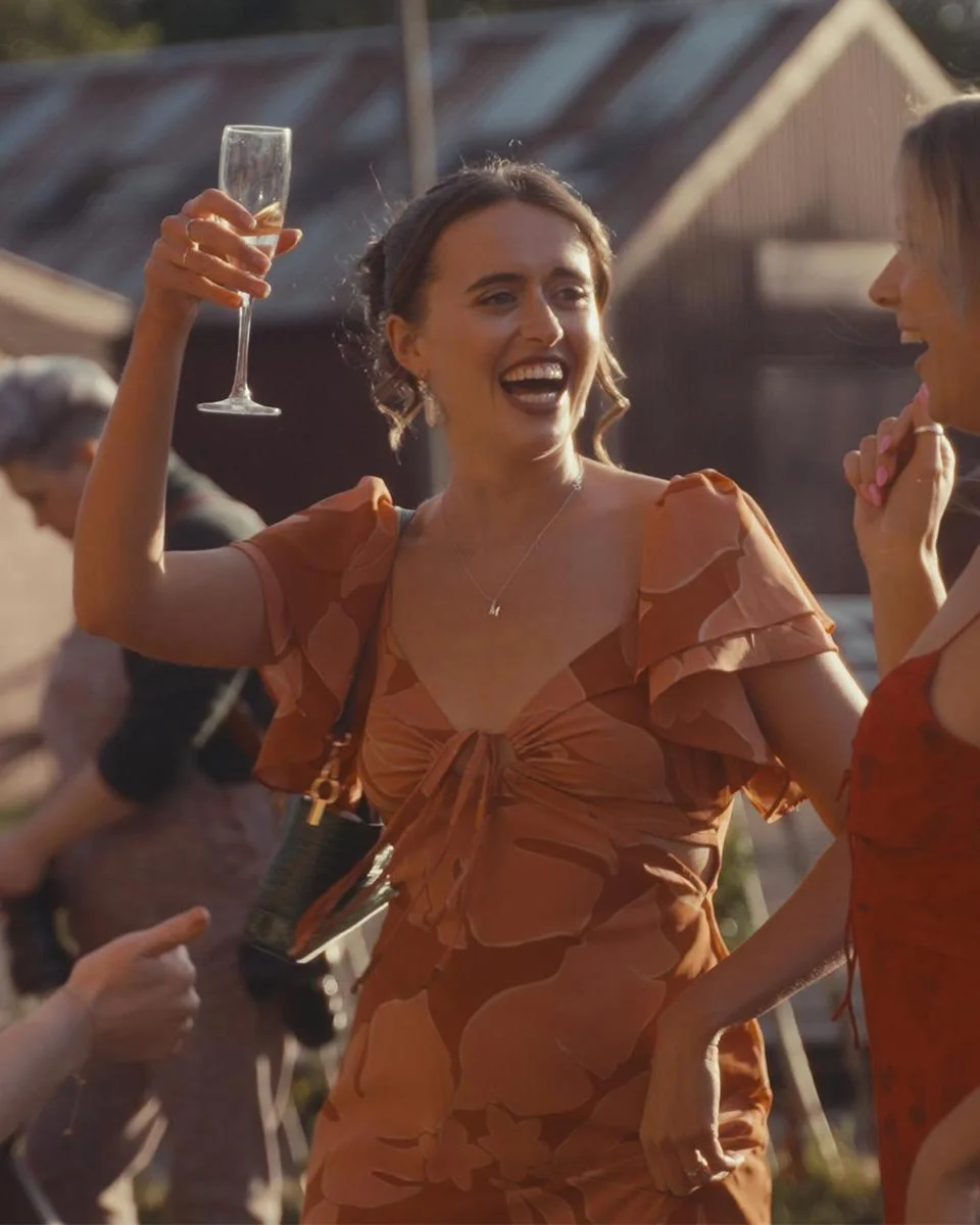 Woman holding a glass of champagne, dancing
