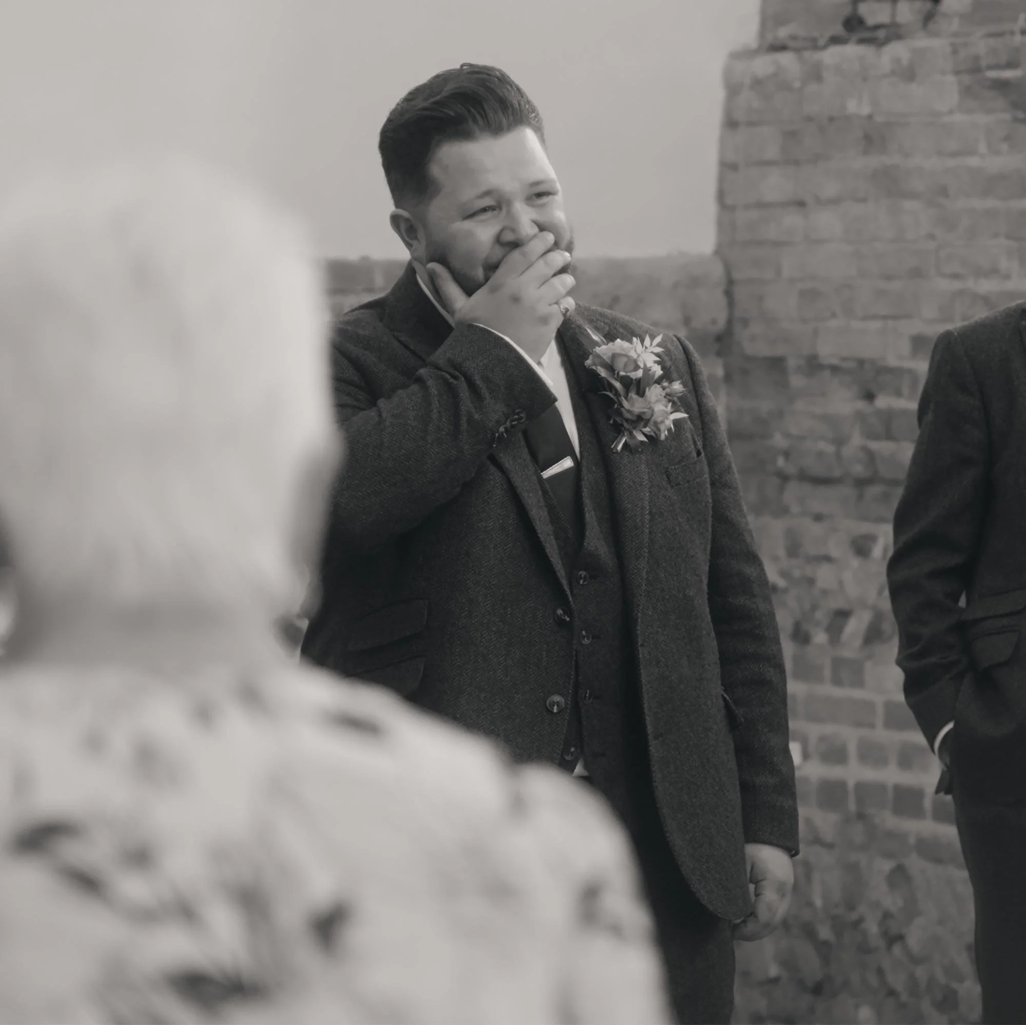 A groom overcome with emotion at the sight of his bride.