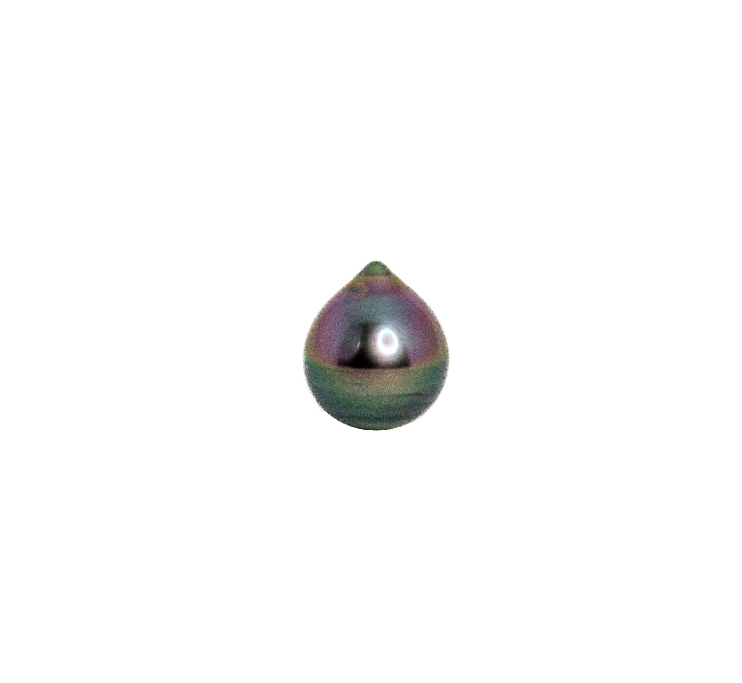 Close-up of a colorful, iridescent droplet-shaped object on a white background.