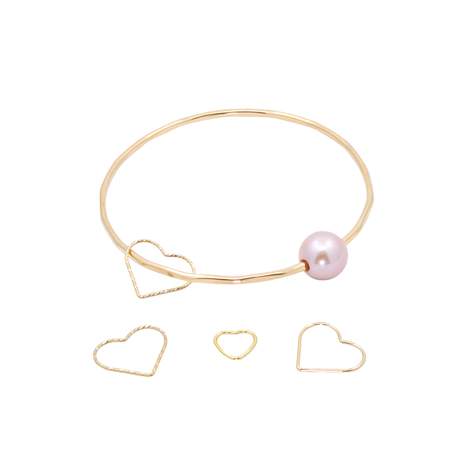 A gold bangle bracelet with a large pearl and a heart-shaped charm. Below are three additional heart-shaped charms in different sizes and colors.