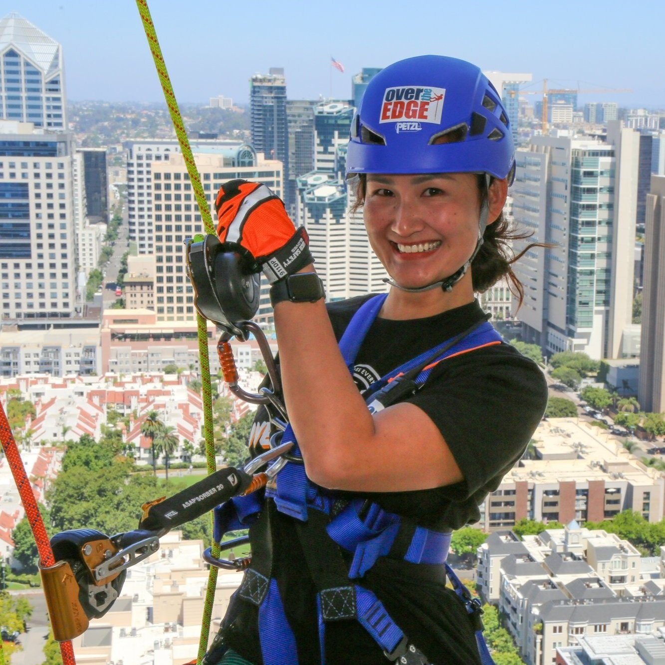 Woman rappelling down a downtown San Diego hotel during an event, captured by Solorio Film Productions.