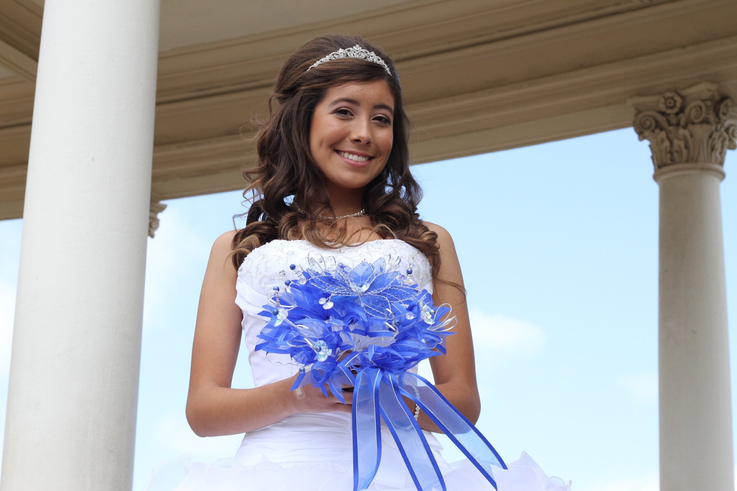 Girl in a Quinceañera dress posing at Balboa Park in San Diego, celebrating her special day.
