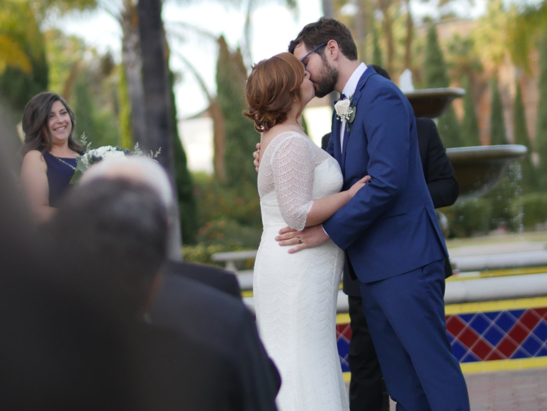 Couple sharing a kiss during their wedding ceremony in San Diego, celebrating their vows and love.