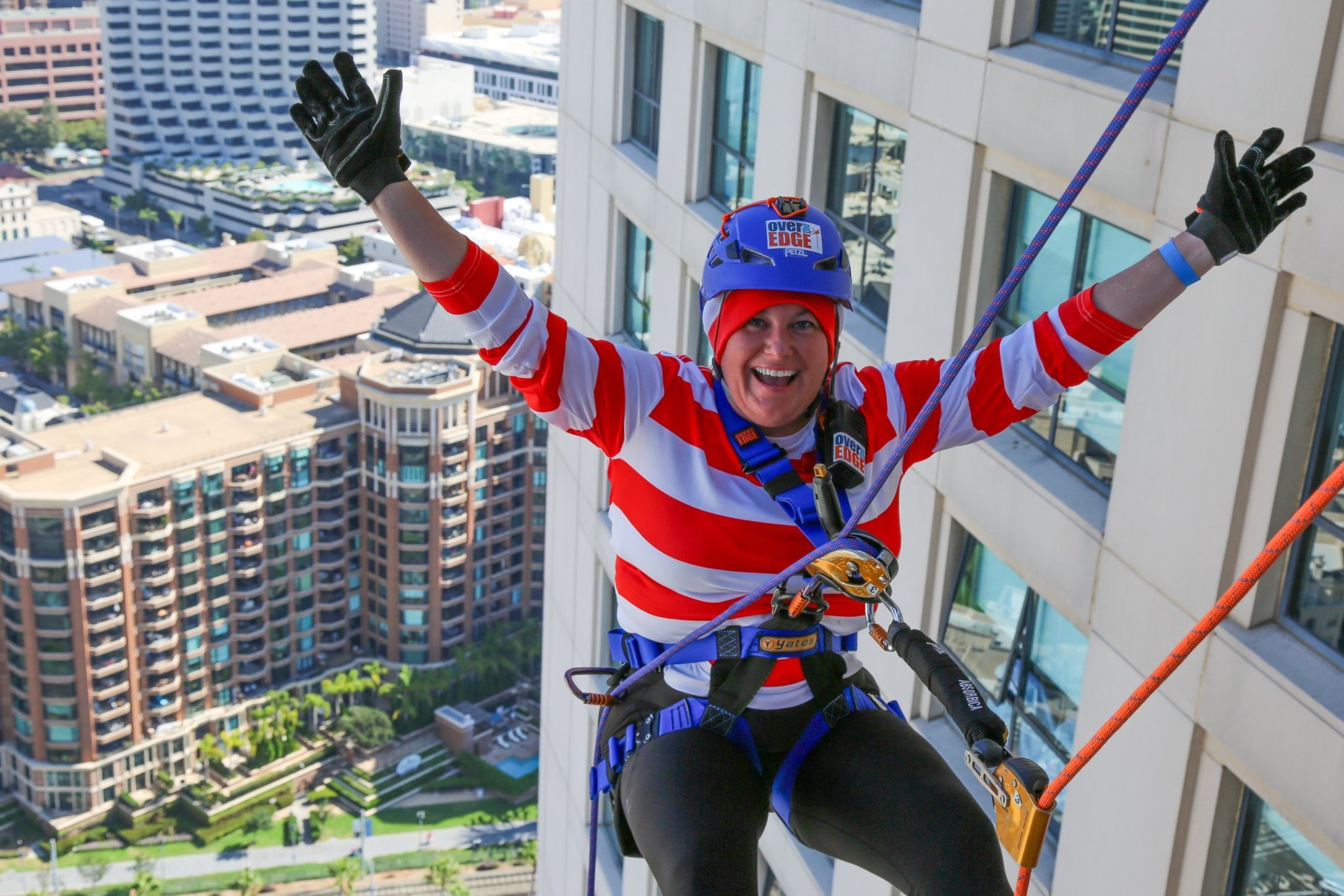 Woman smiling and enjoying herself at a community event held at a hotel in downtown San Diego.