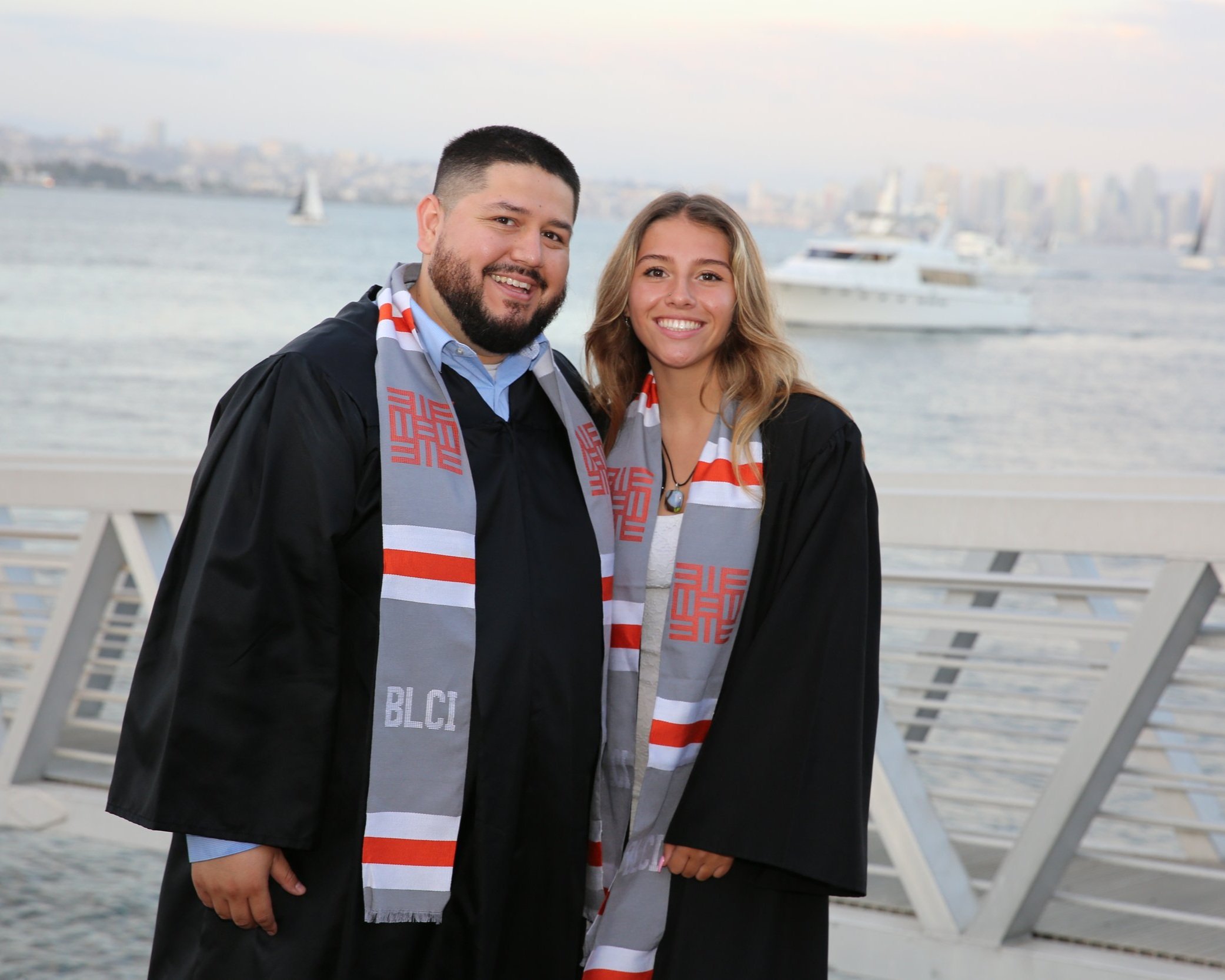 Father and daughter celebrating graduation at Barrio Logan College Institute in San Diego, symbolizing educational achievement and family pride.