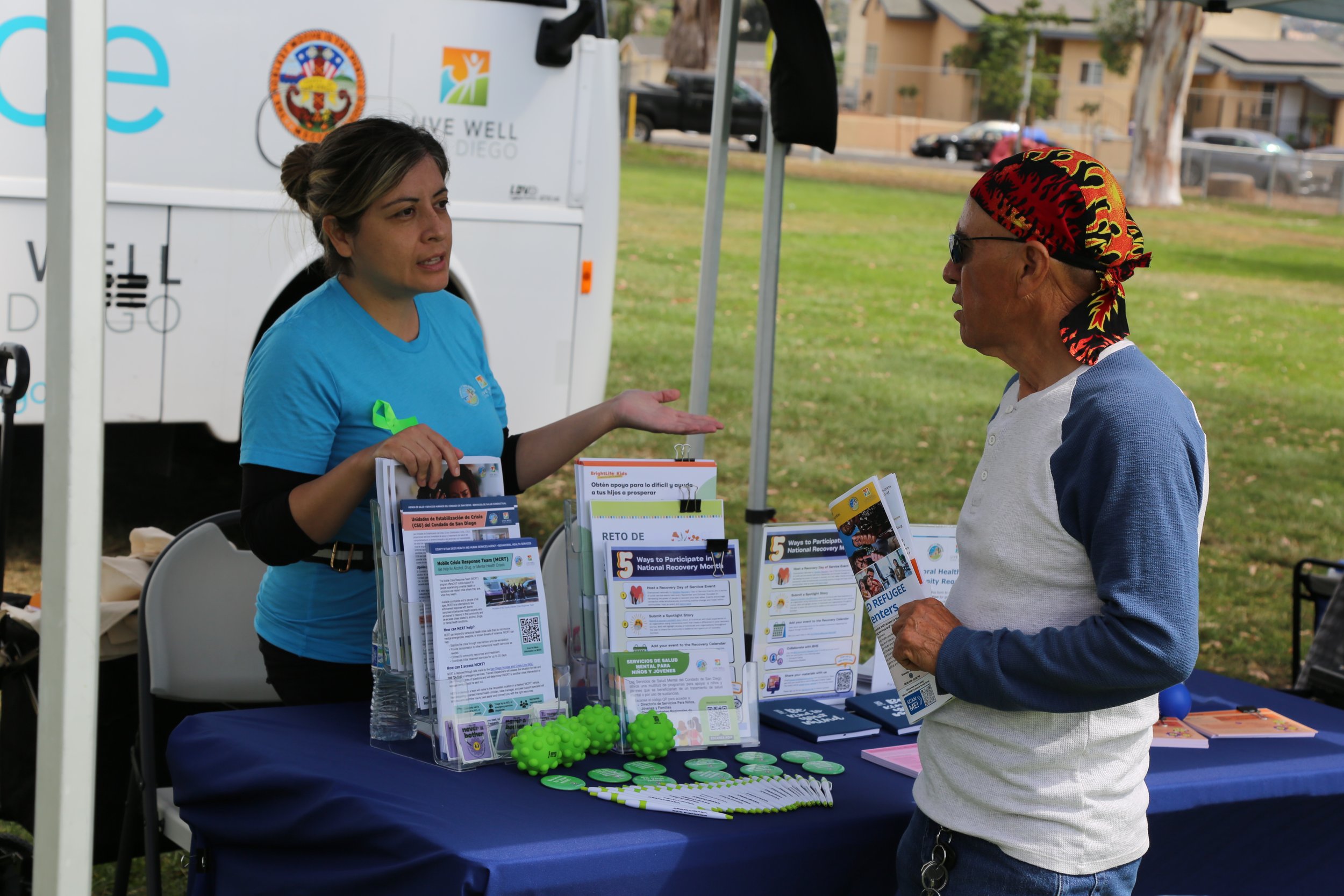 Local vendor providing services to community member at a neighborhood event in San Diego.