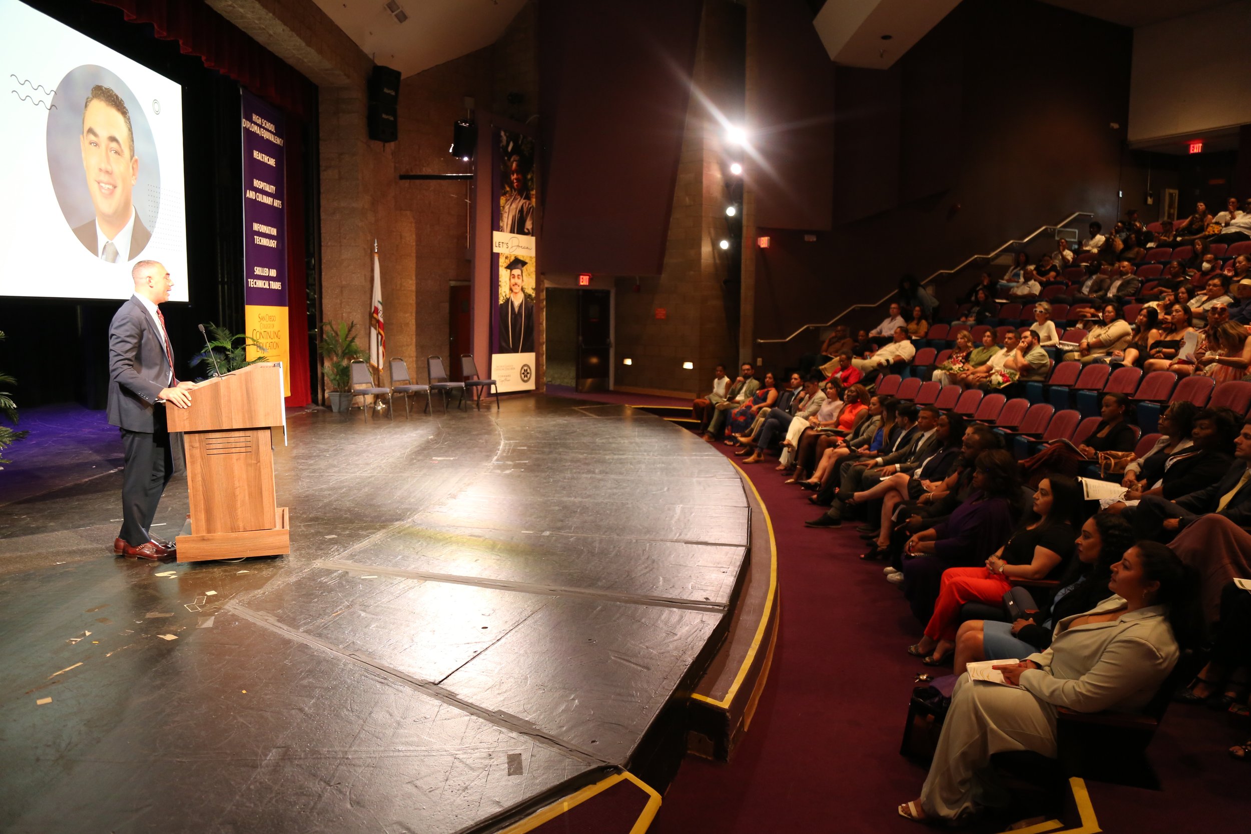 Speaker addressing a professional audience at a networking event in San Diego, fostering business connections and community engagement.