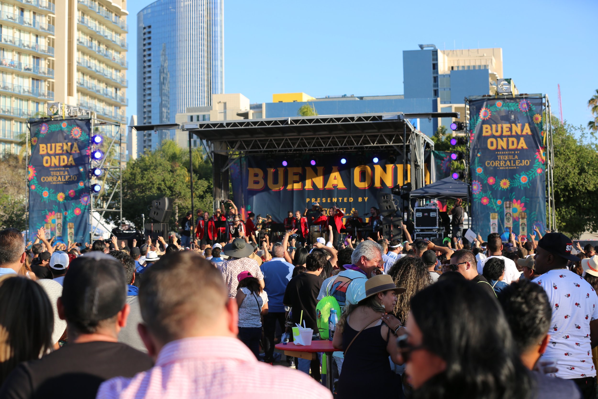Buena Onda band performing live at a concert in downtown San Diego, celebrating local music and community culture.