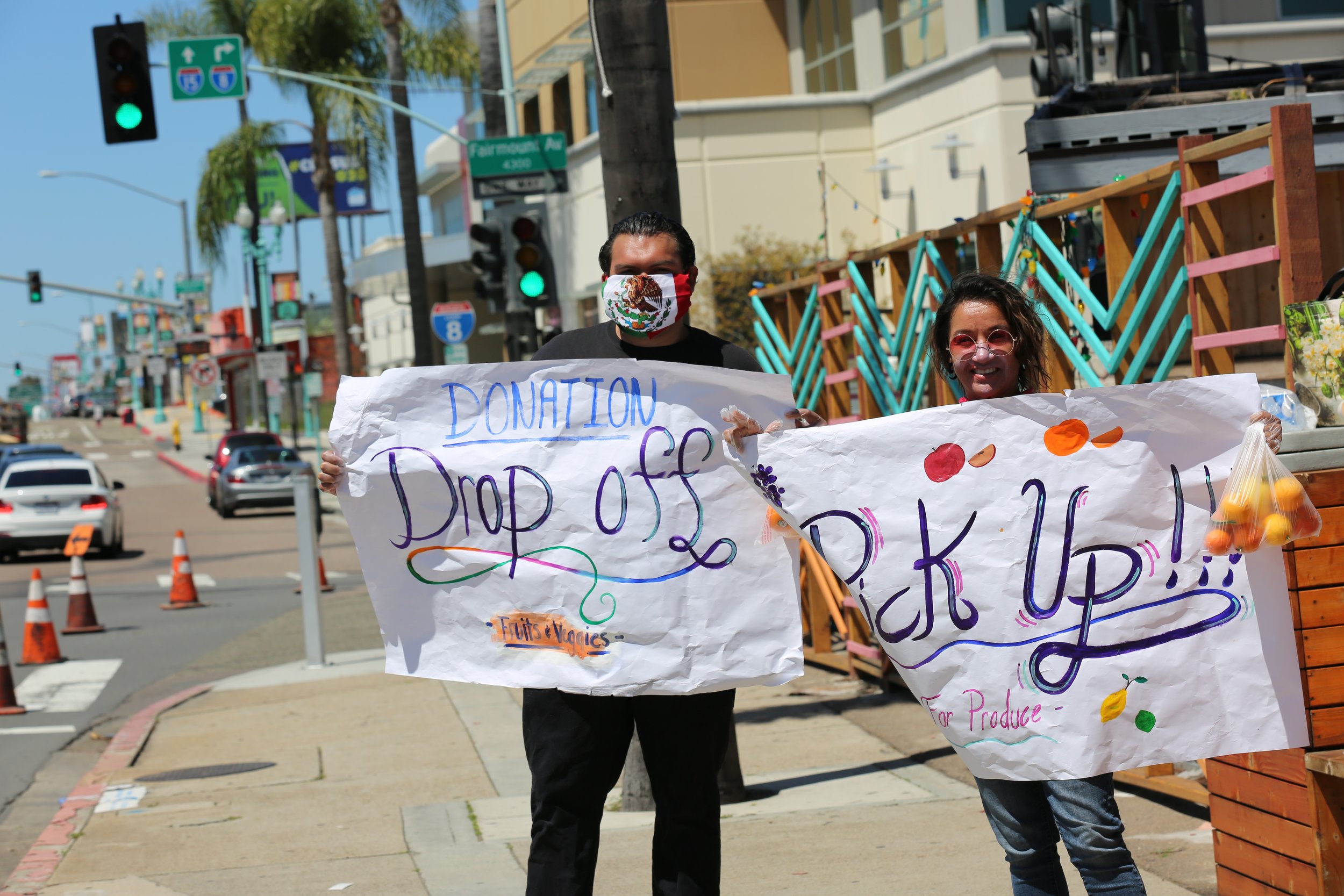 People coordinating food donation pickups and drop-offs at a community event in San Diego, promoting local food security.
