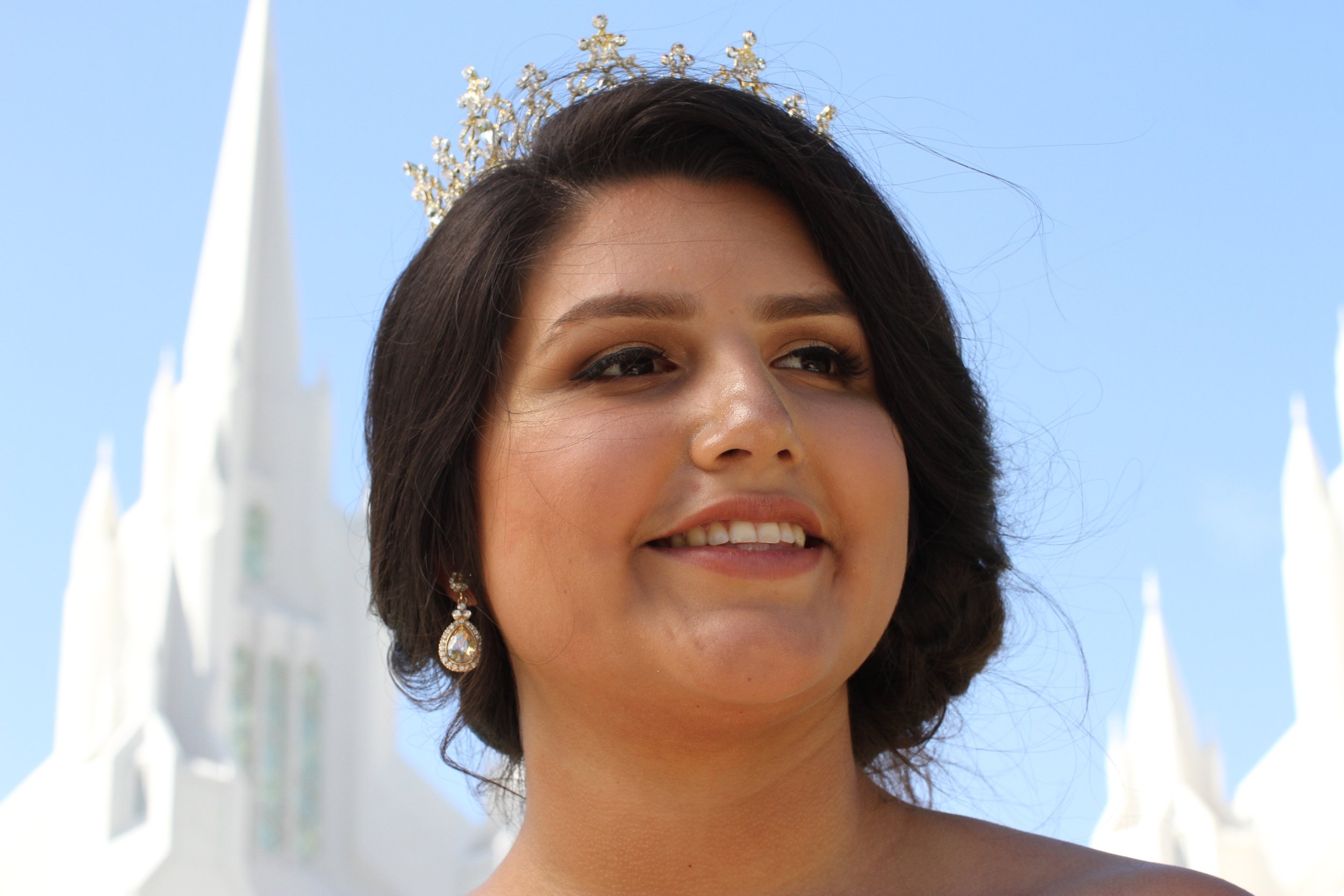 Quinceañera girl in a beautiful dress attending a church ceremony in La Jolla, celebrating her milestone in San Diego.