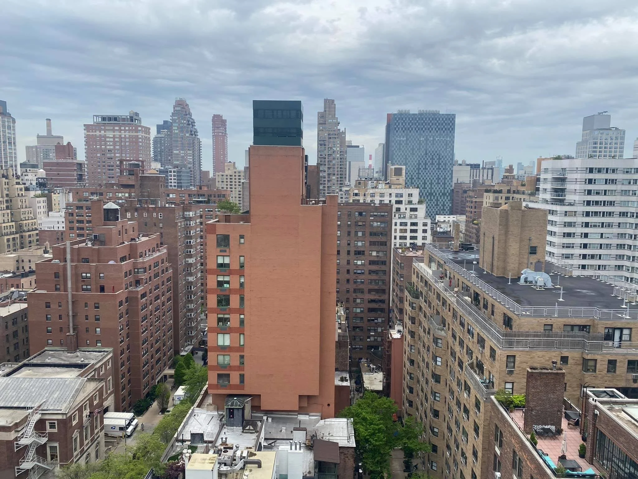 City skyline with tall buildings and cloudy sky.