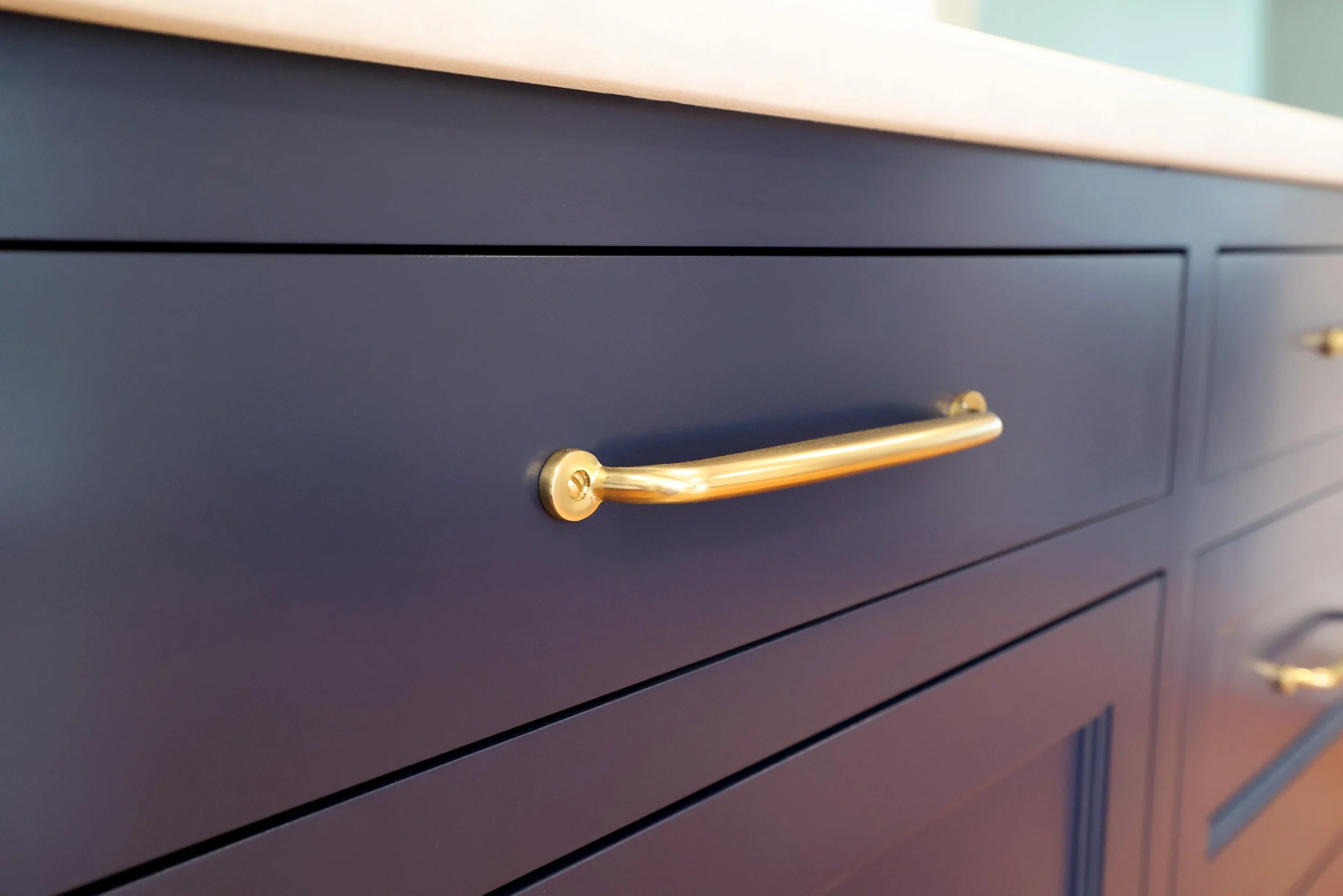 naval blue by shermin williams shaker cabinetry with soft brass hardware in a Vermont kitchen remodel.