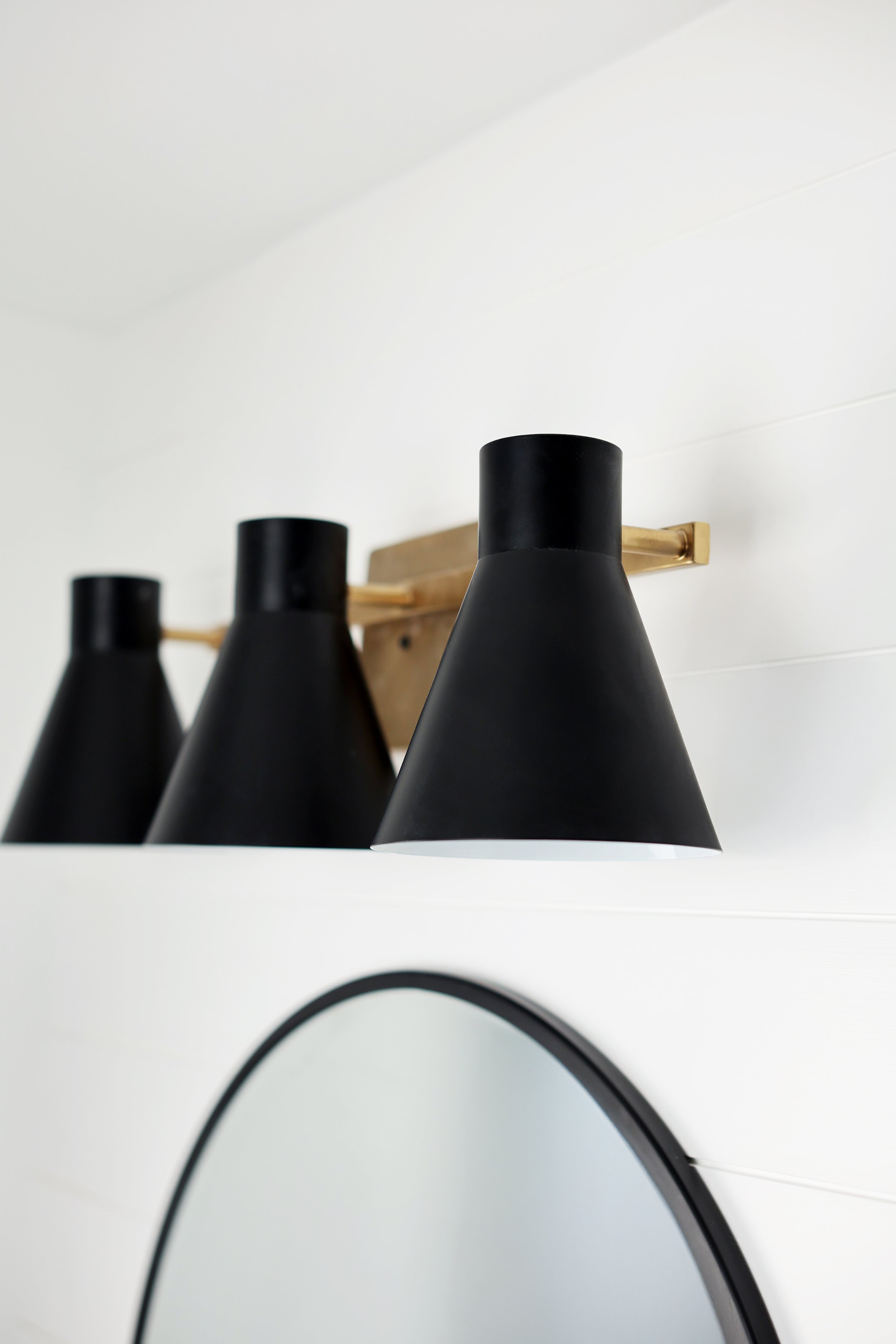 Bathroom lighting and decor detail in a modern ski house bathroom in Burke Vermont.