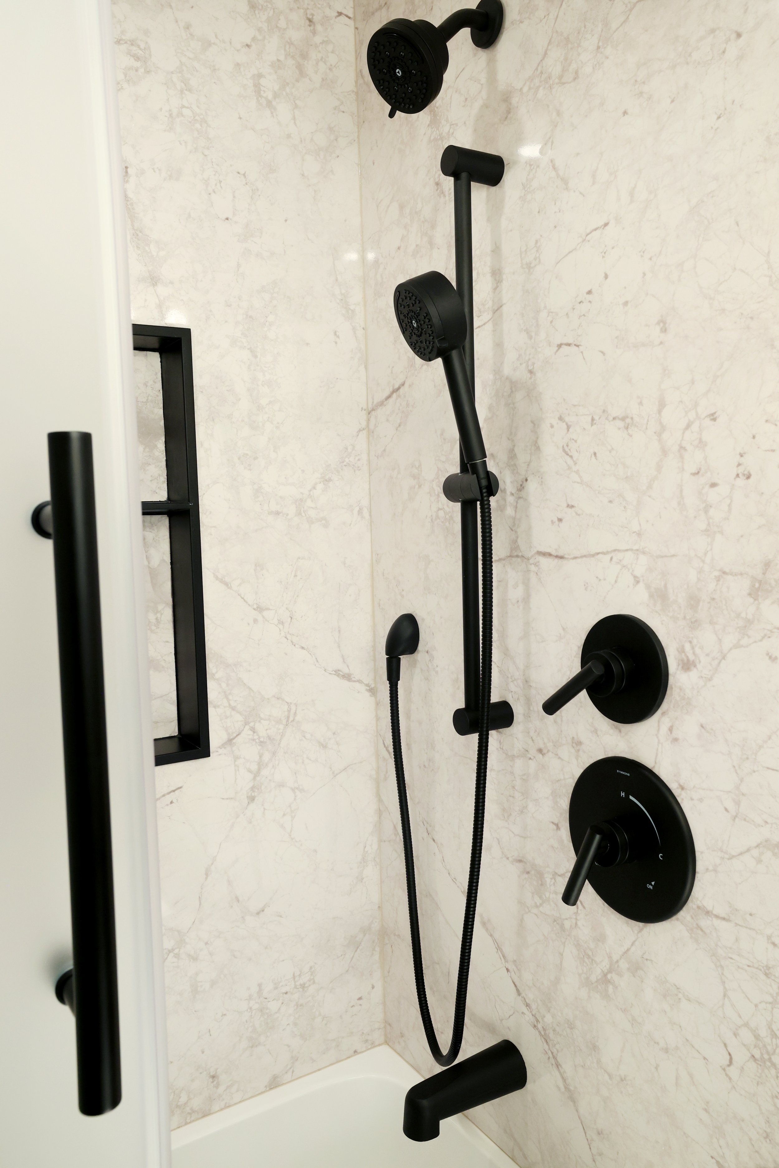 Matte black shower fixtures installed in a Castico shower system in a Hanover NH bathroom.