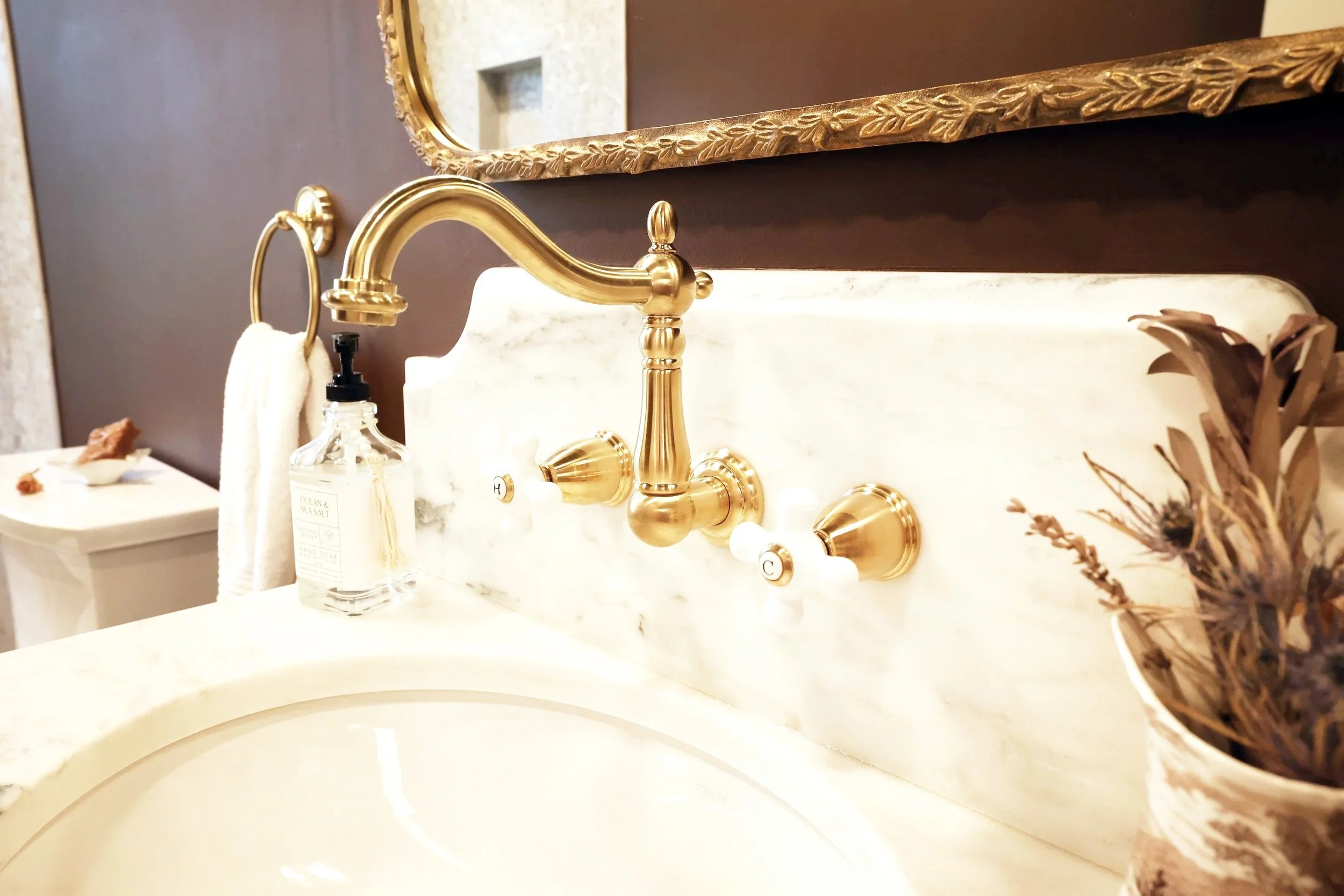 high-end bathroom renovation with marble and brass finishes designed to increase property value in New England