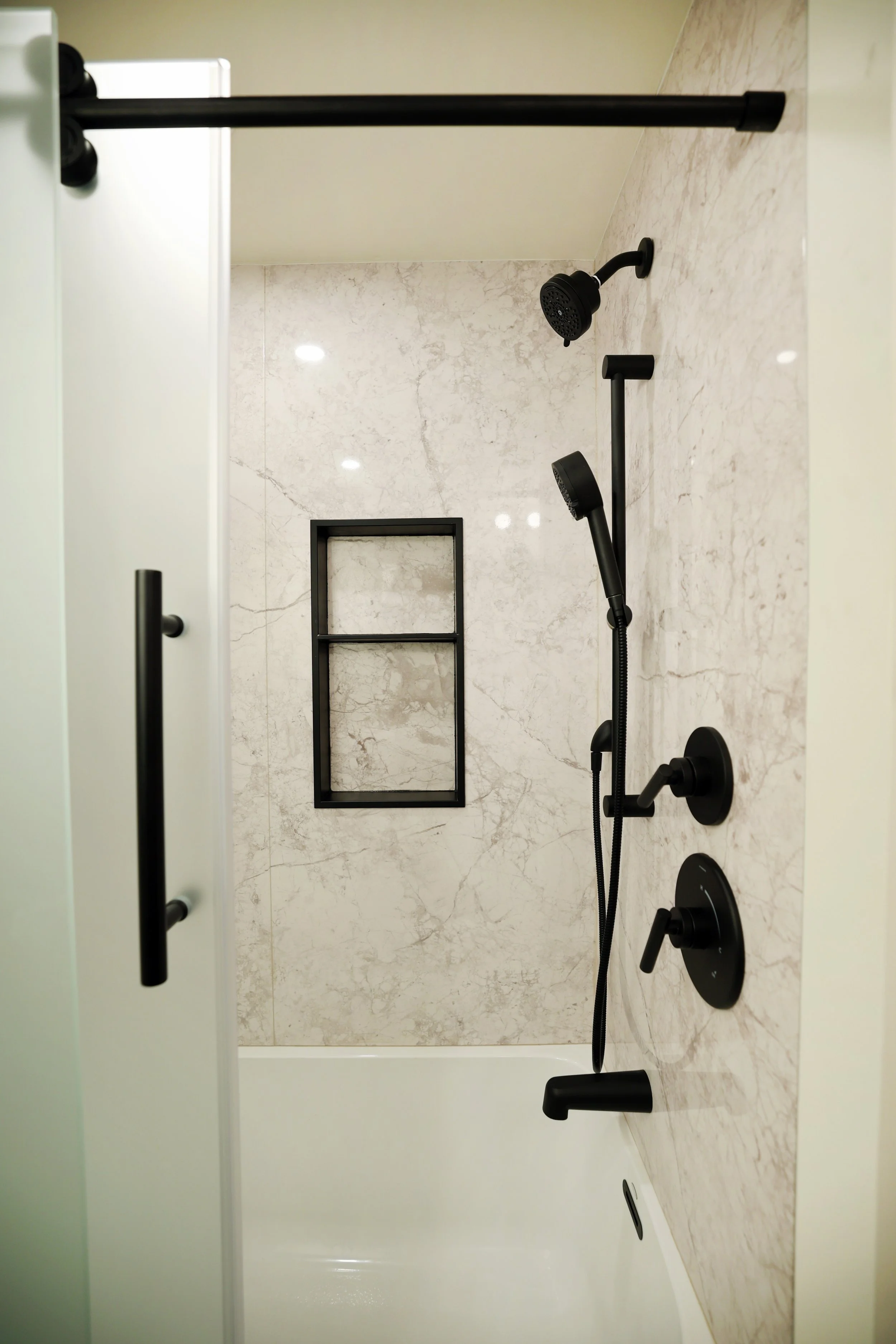 Castico shower system with matte black fixtures in a Hanover New Hampshire bathroom renovation.
