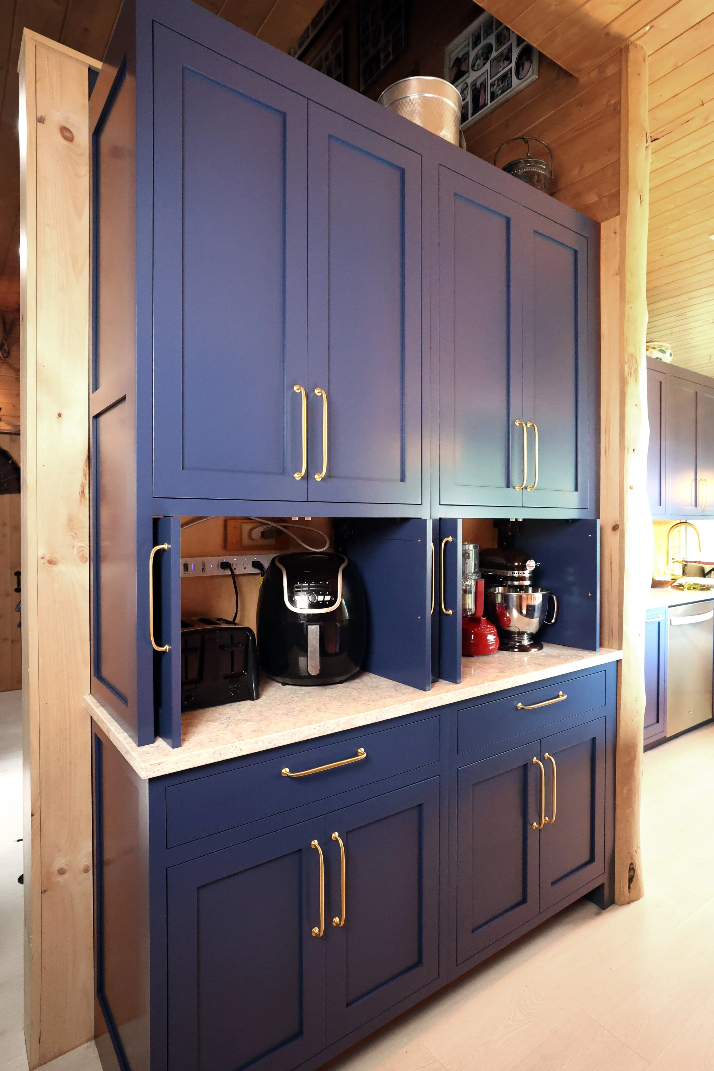 Built-in appliance garage within Crown Point cabinetry in a New Hampshire lodge kitchen.