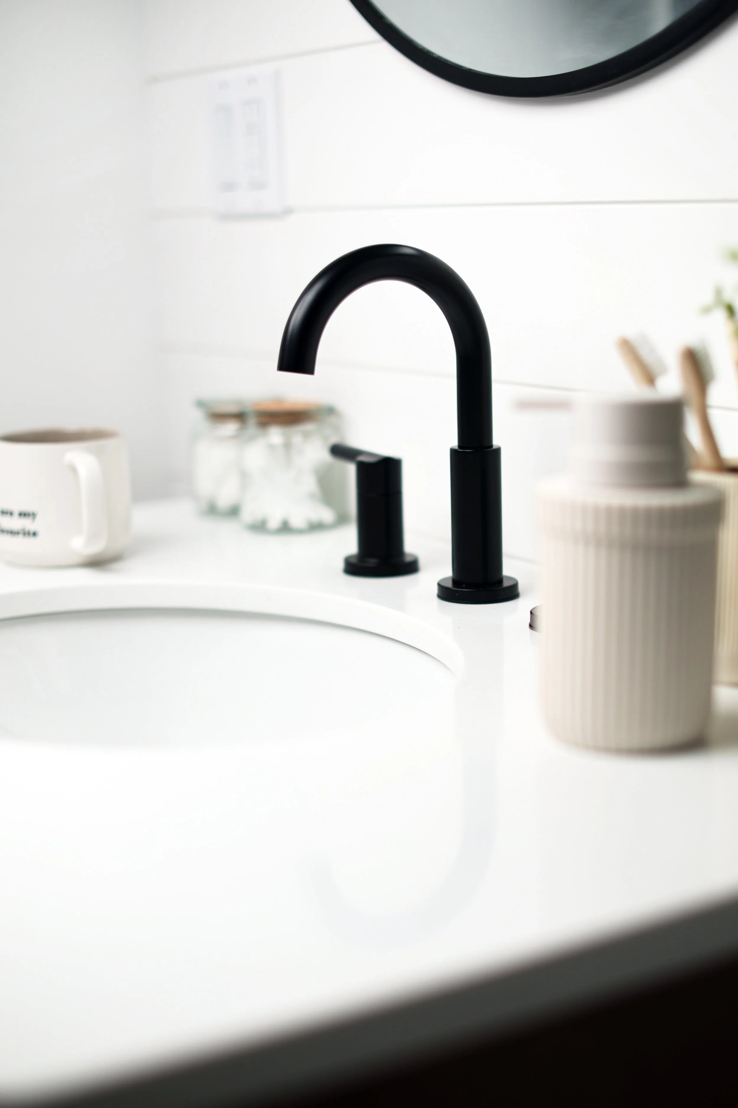 Matte black Kohler faucet detail in a modern ski house bathroom in Burke Vermont.