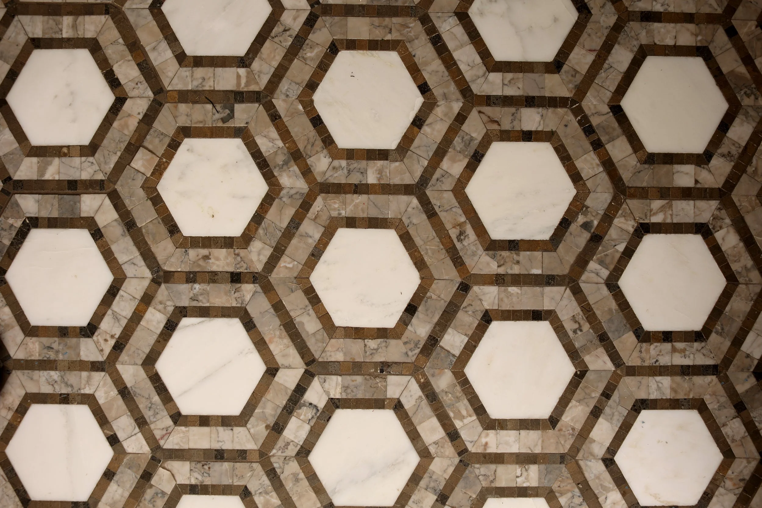 Geometric marble mosaic tile floor in a classic powder room renovation in Thetford Vermont.