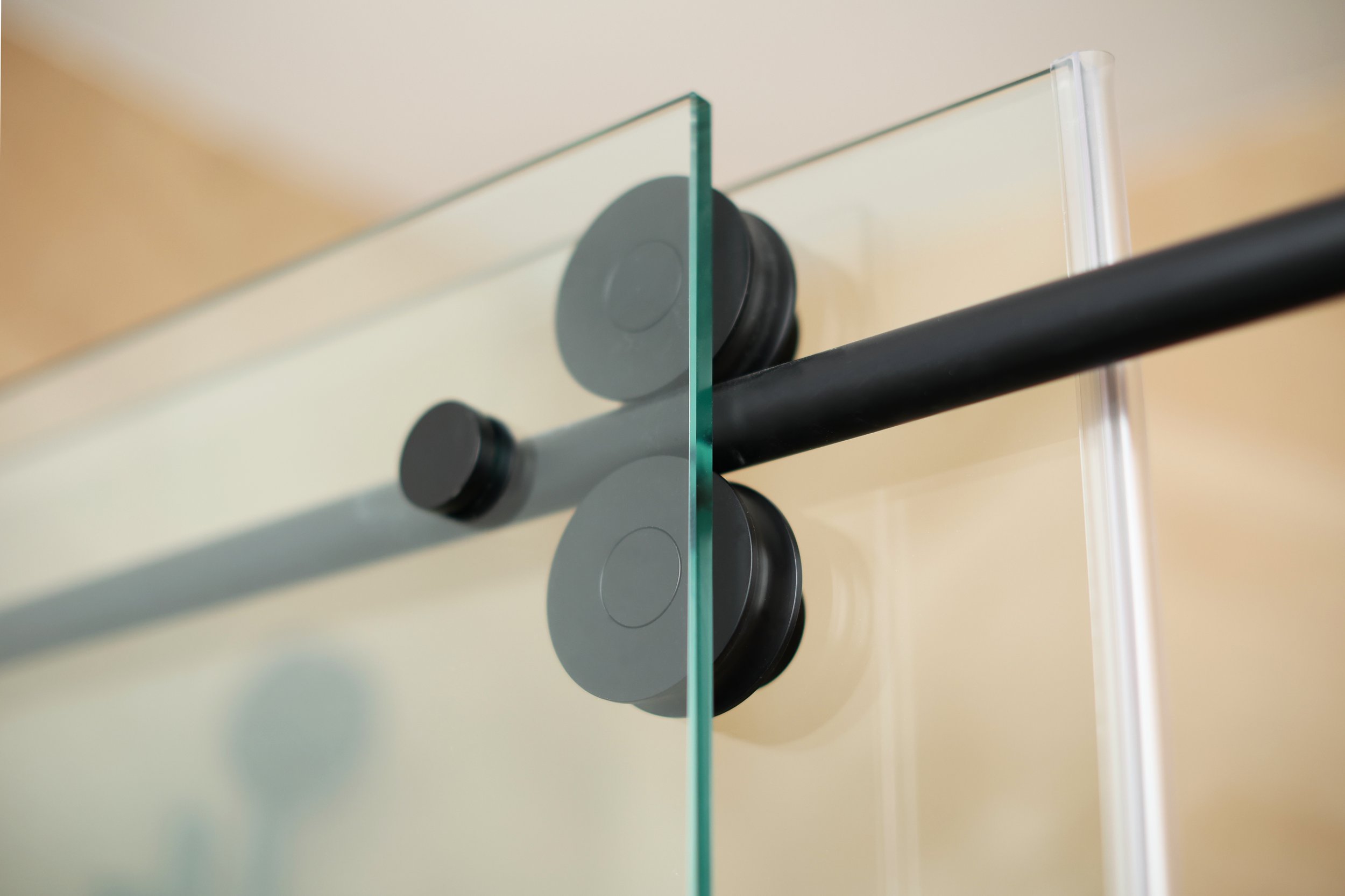 Matte black shower glass hardware detail in a modern ski home bathroom in Burke VT.