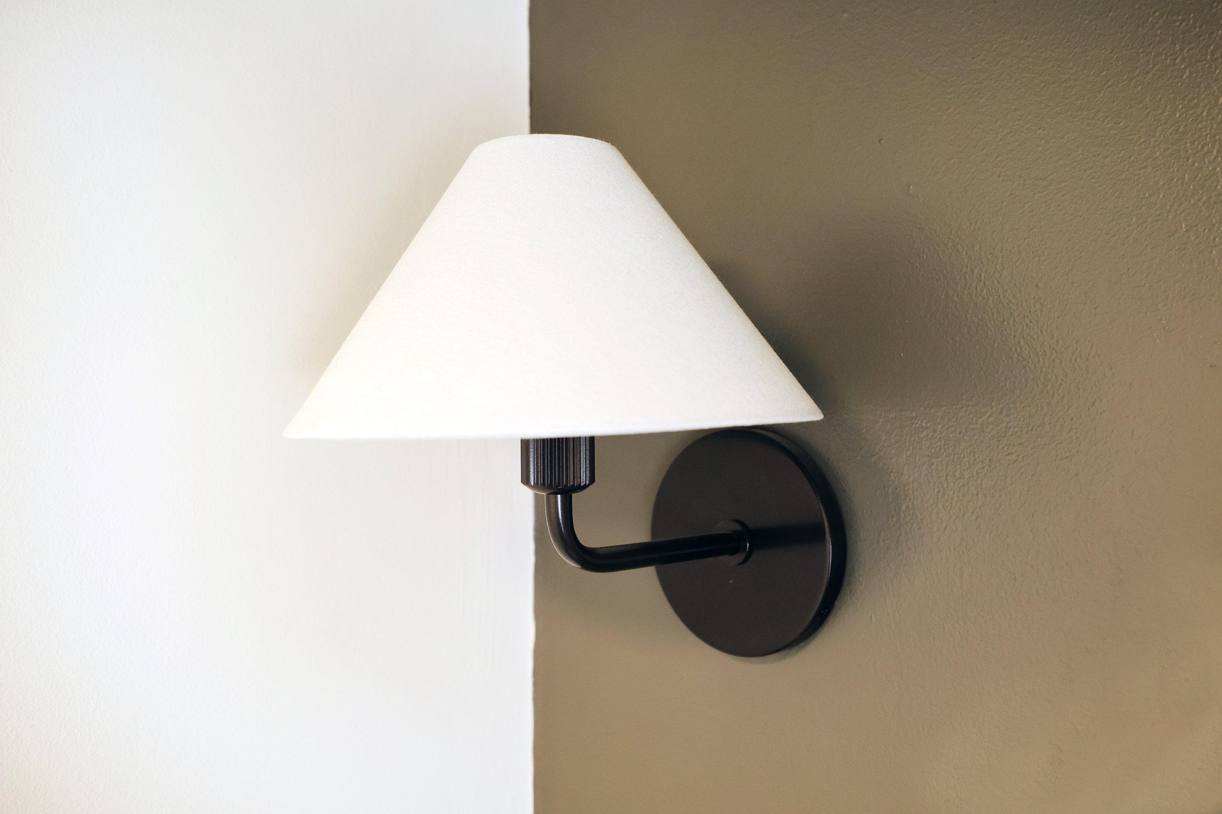 Traditional wall sconce with fabric shade in a classic Upper Valley powder room.