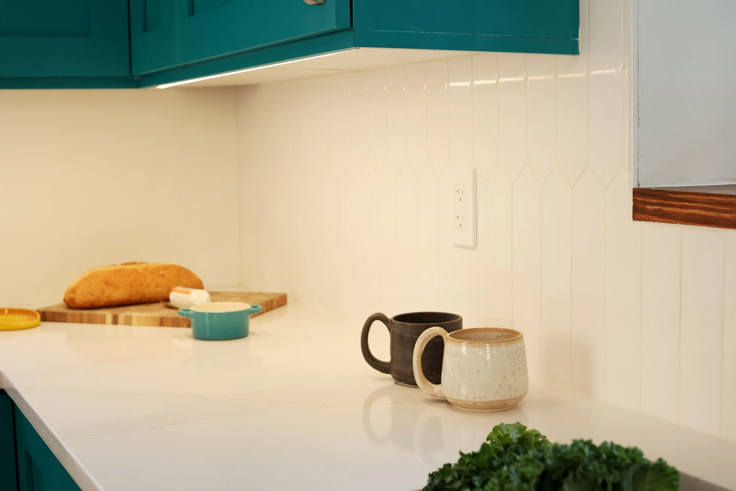 Corner kitchen countertop with teal cabinetry painted Benjamin Moore Gulf Shores in White River Junction VT.