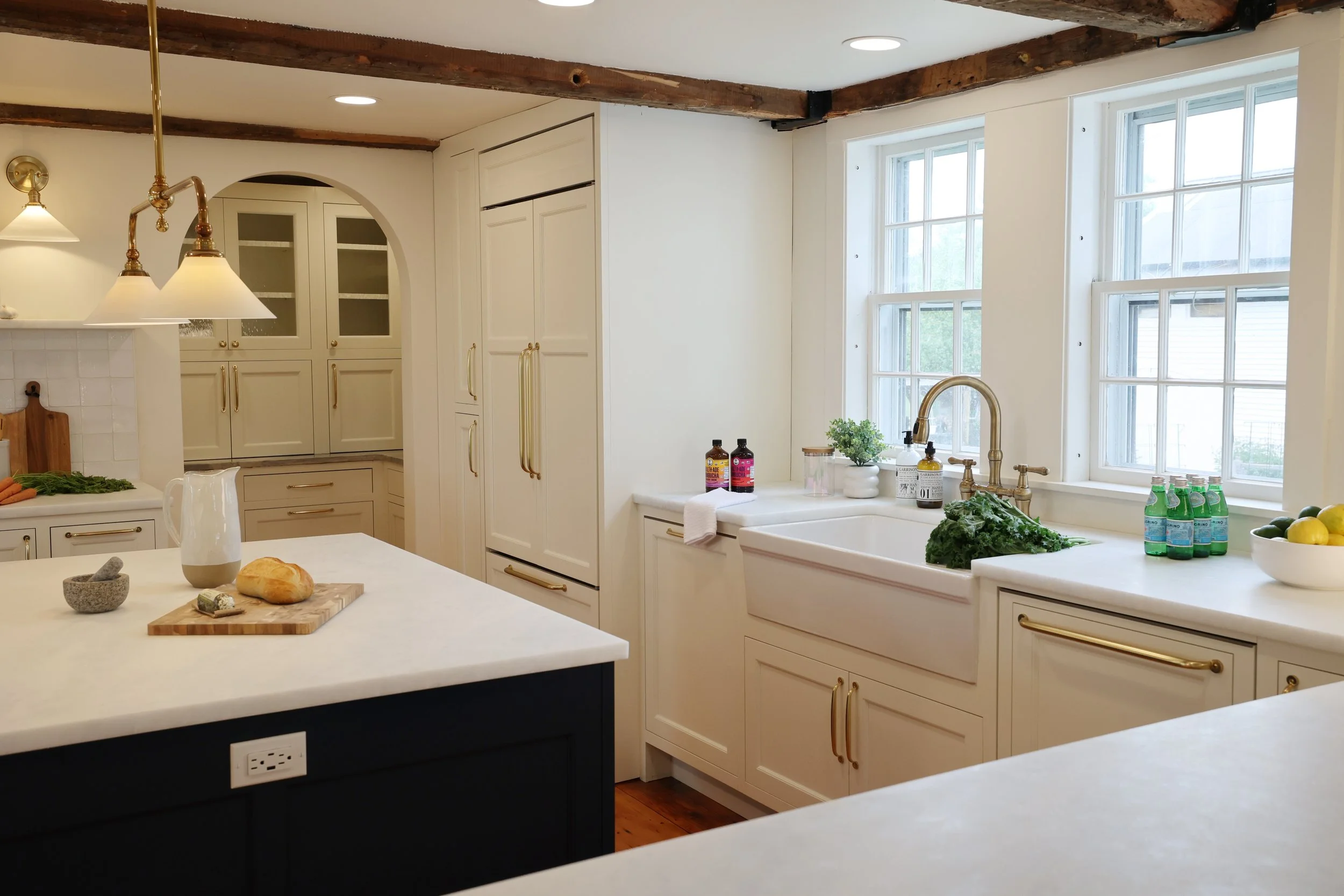 Marble countertops paired with warm neutral cabinetry in a Vermont kitchen remodel.