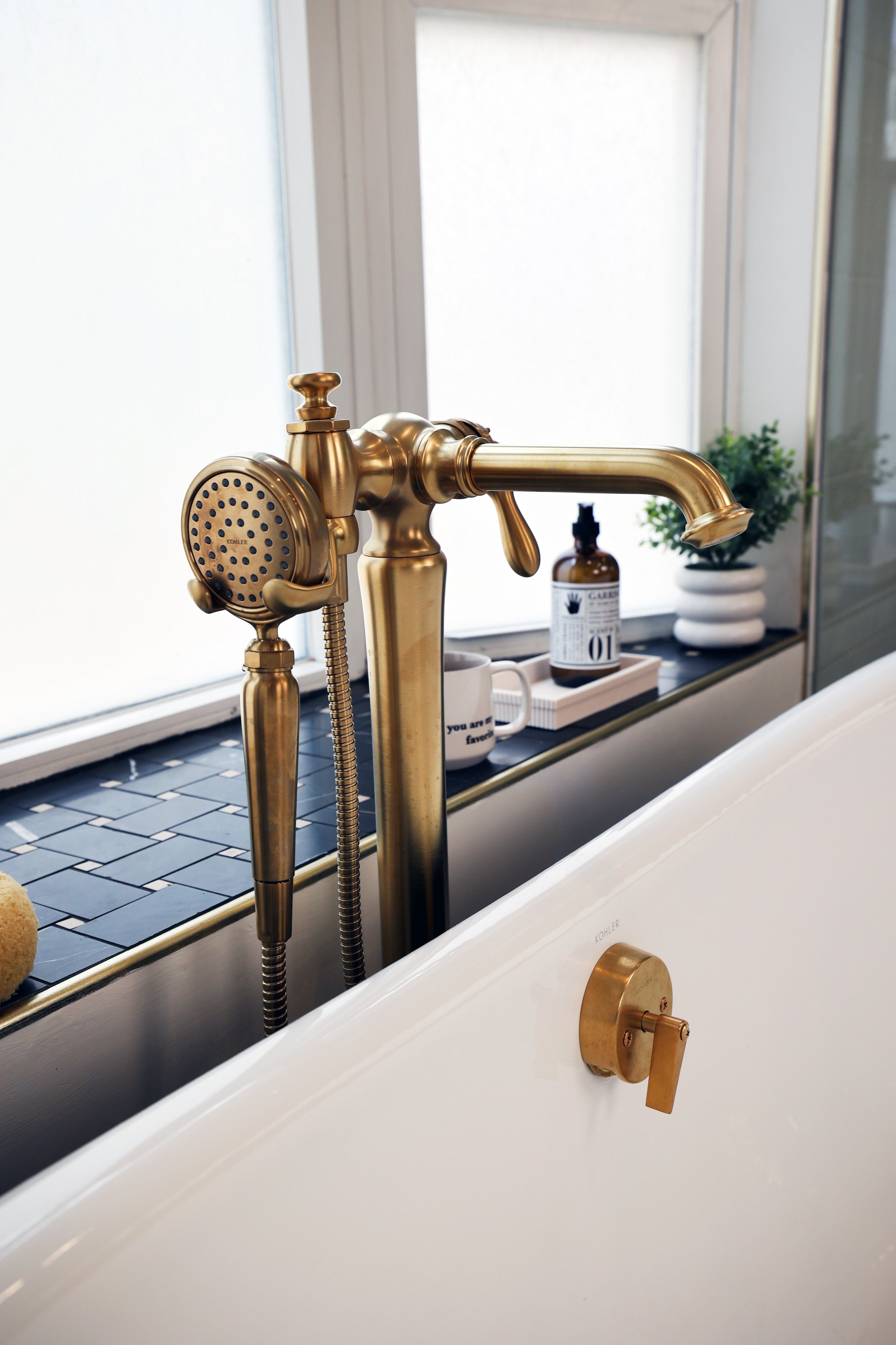 Brass tub filler from Kohler artifacts collection in a victorian home renovation in Bethlehem New Hampshire.