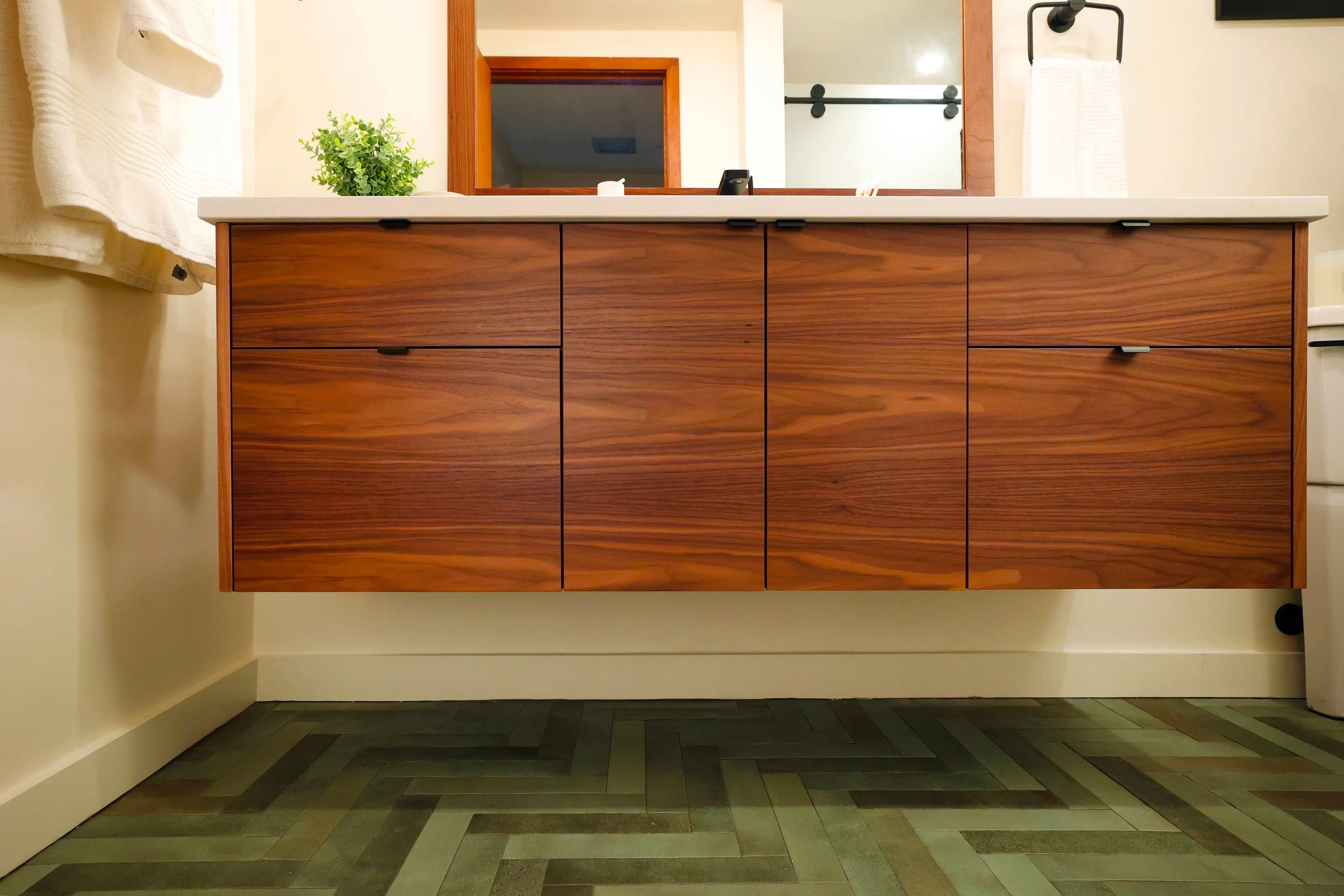 Floating walnut vanity by Teodor Vanities in a midcentury bathroom renovation in Hanover New Hampshire.