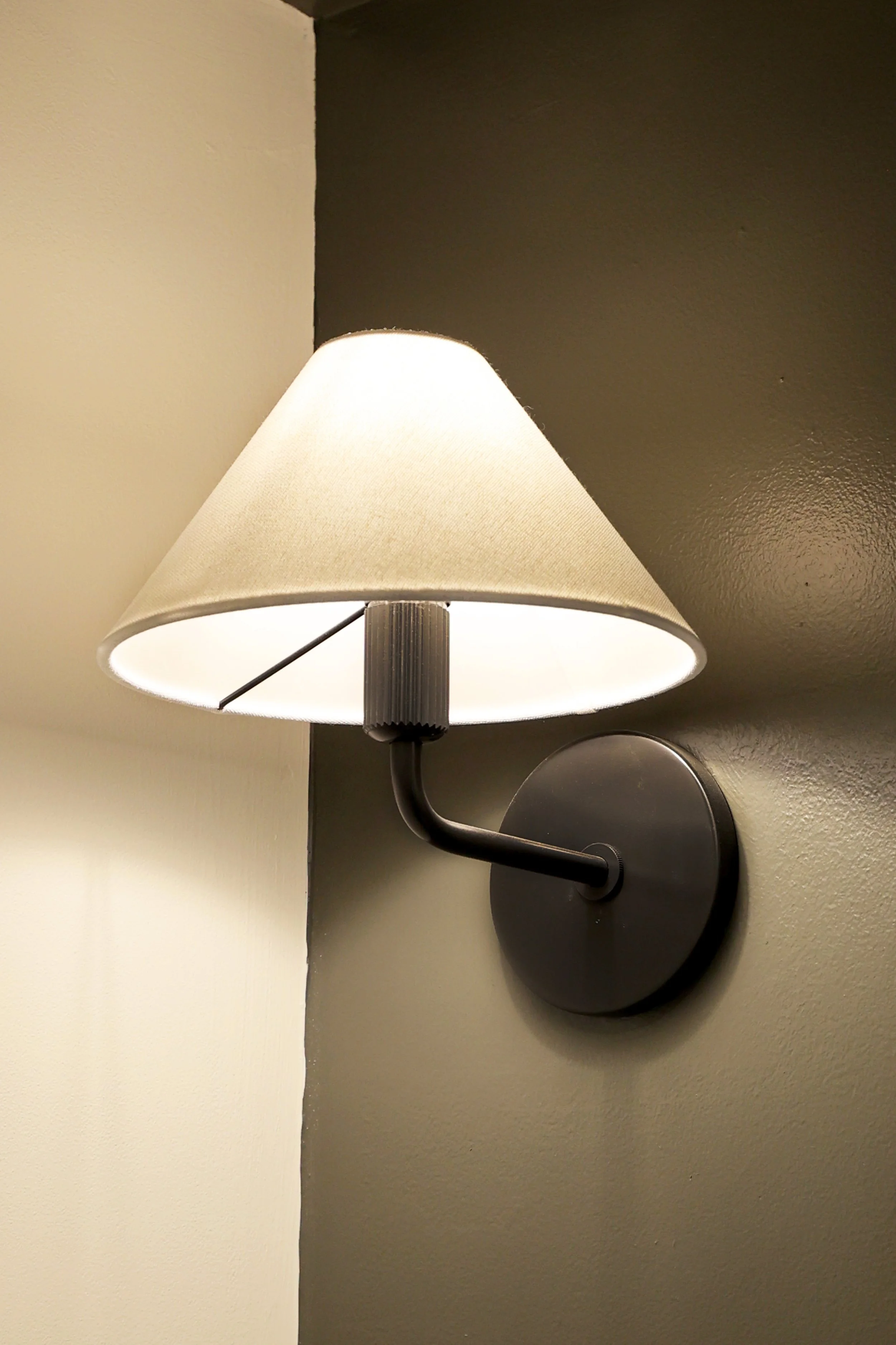 Traditional wall sconce lighting detail in a classic powder room renovation in the Upper Valley.